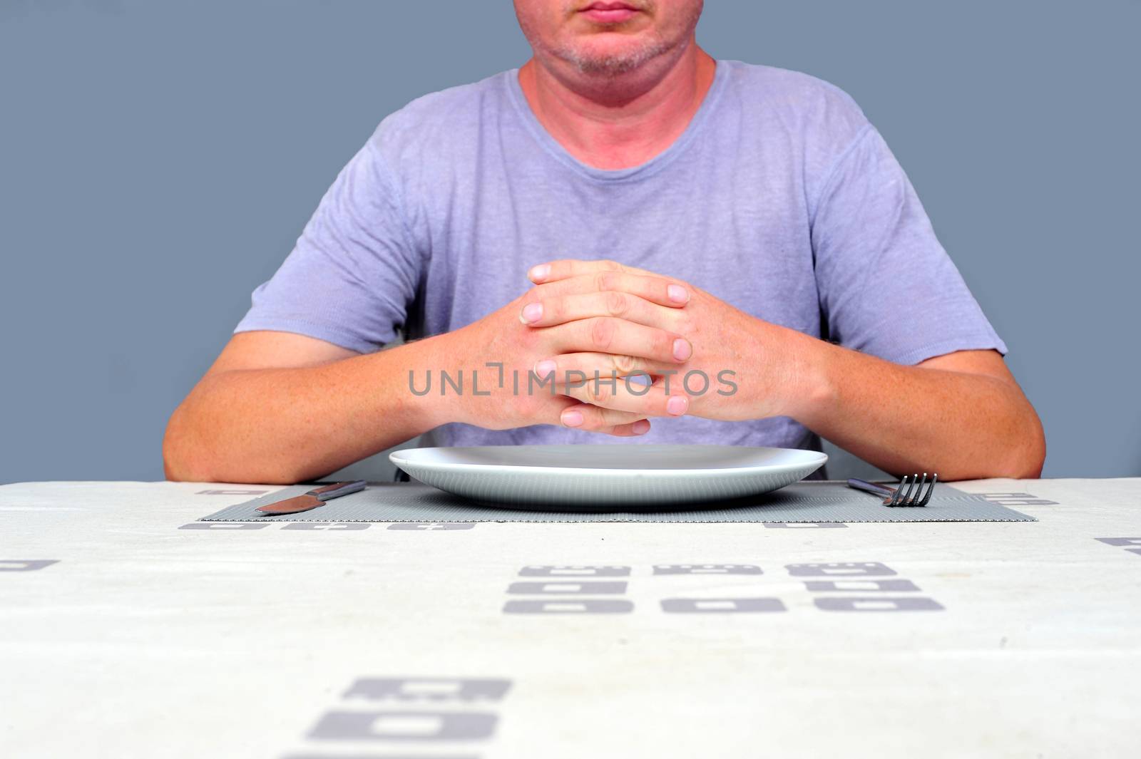 Gentleman waiting at a table waiting to eat alone