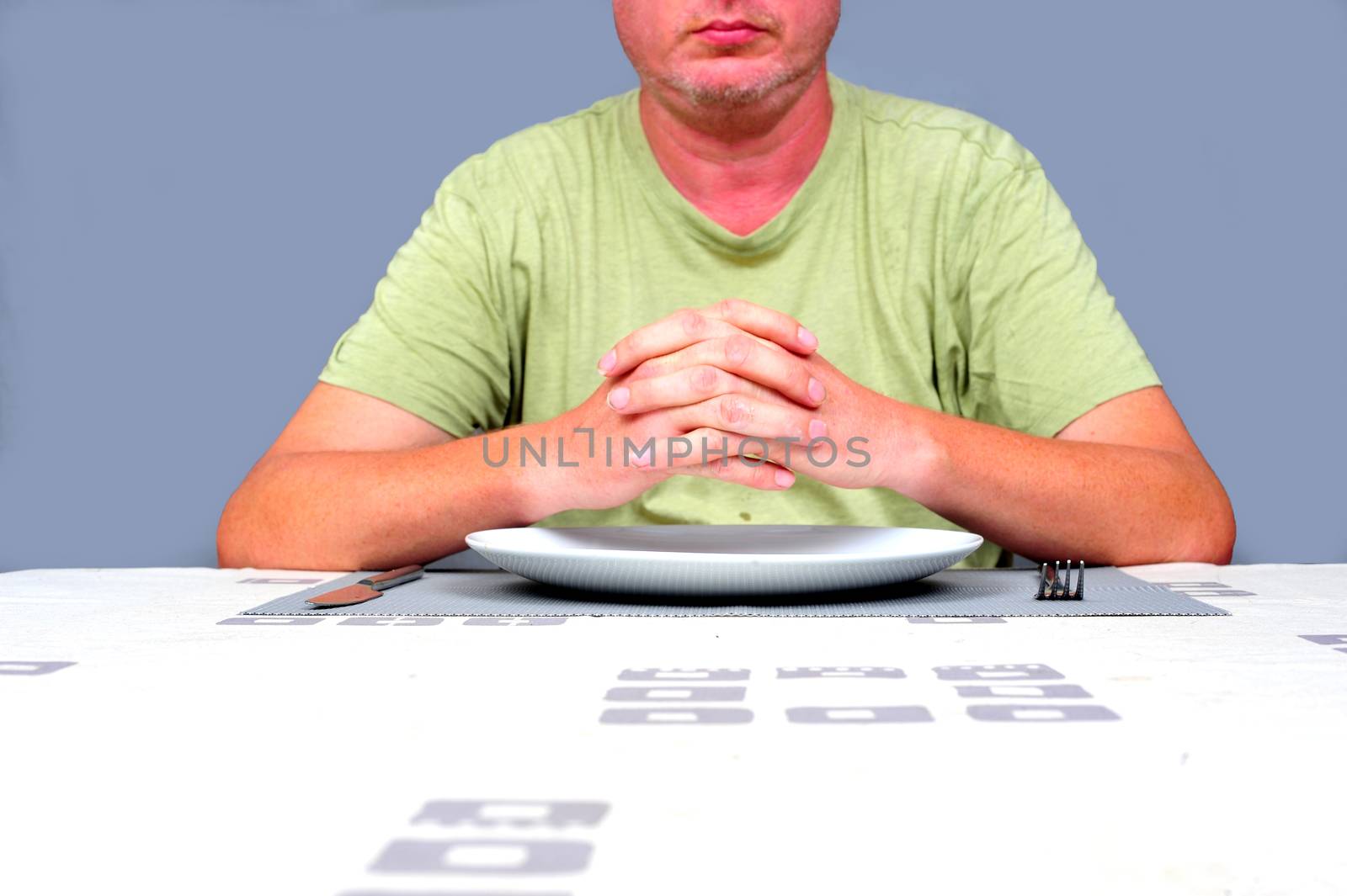 Gentleman waiting at a table waiting to eat alone