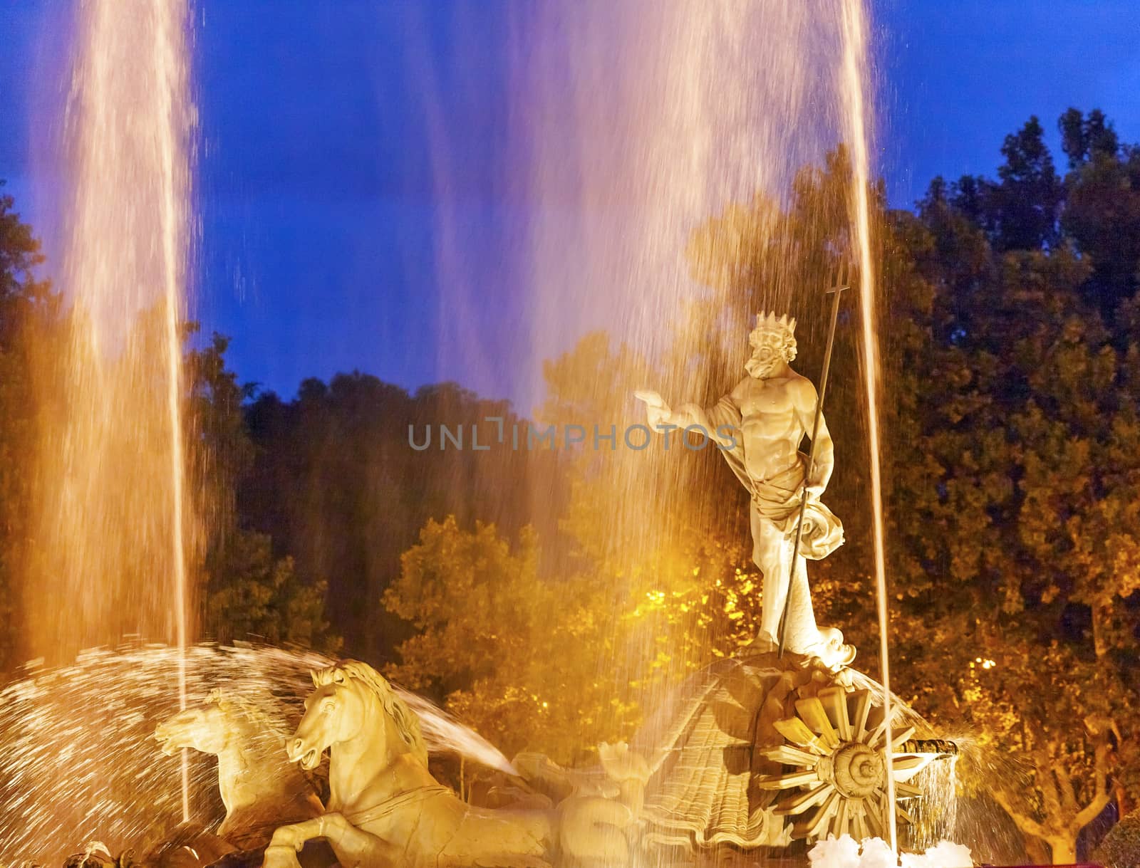 Neptune with Trident Snake in Chariot, Roman God, Statue Fountain Fuento de Neptuno Night Plaza Canovas del Castillo Madrid Spain.  Neptune Statue designed in 1780 by Ventura Rodriguez as part of Carolos III's scheme to beautify Madrid, Spain.