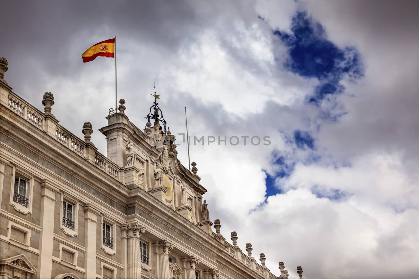 Royal Palace Palacio Real Clouds Sky Cityscape Spanish Flag Madrid Spain.  Phillip 5 rreconstructed palace in the 1700s.