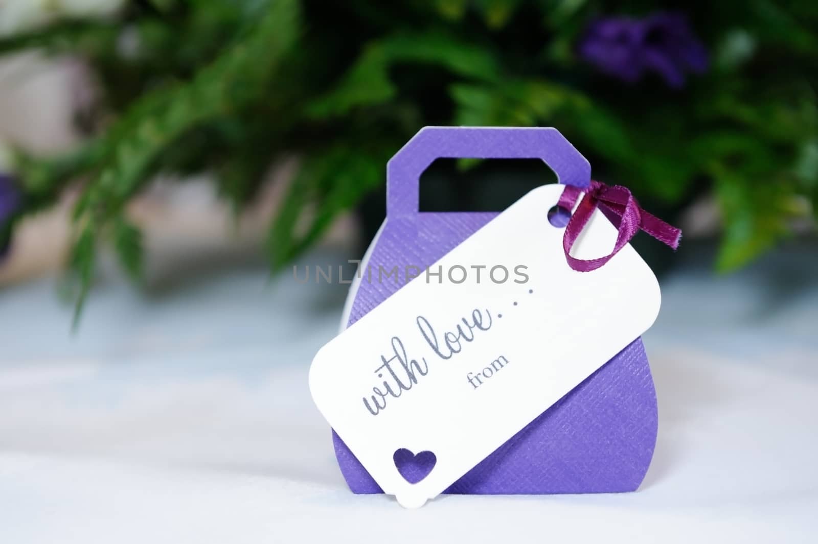 Closeup of violet wedding favours gift at wedding reception