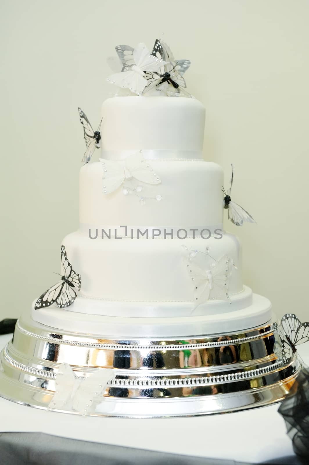 White wedding cake with black butterfly decoration