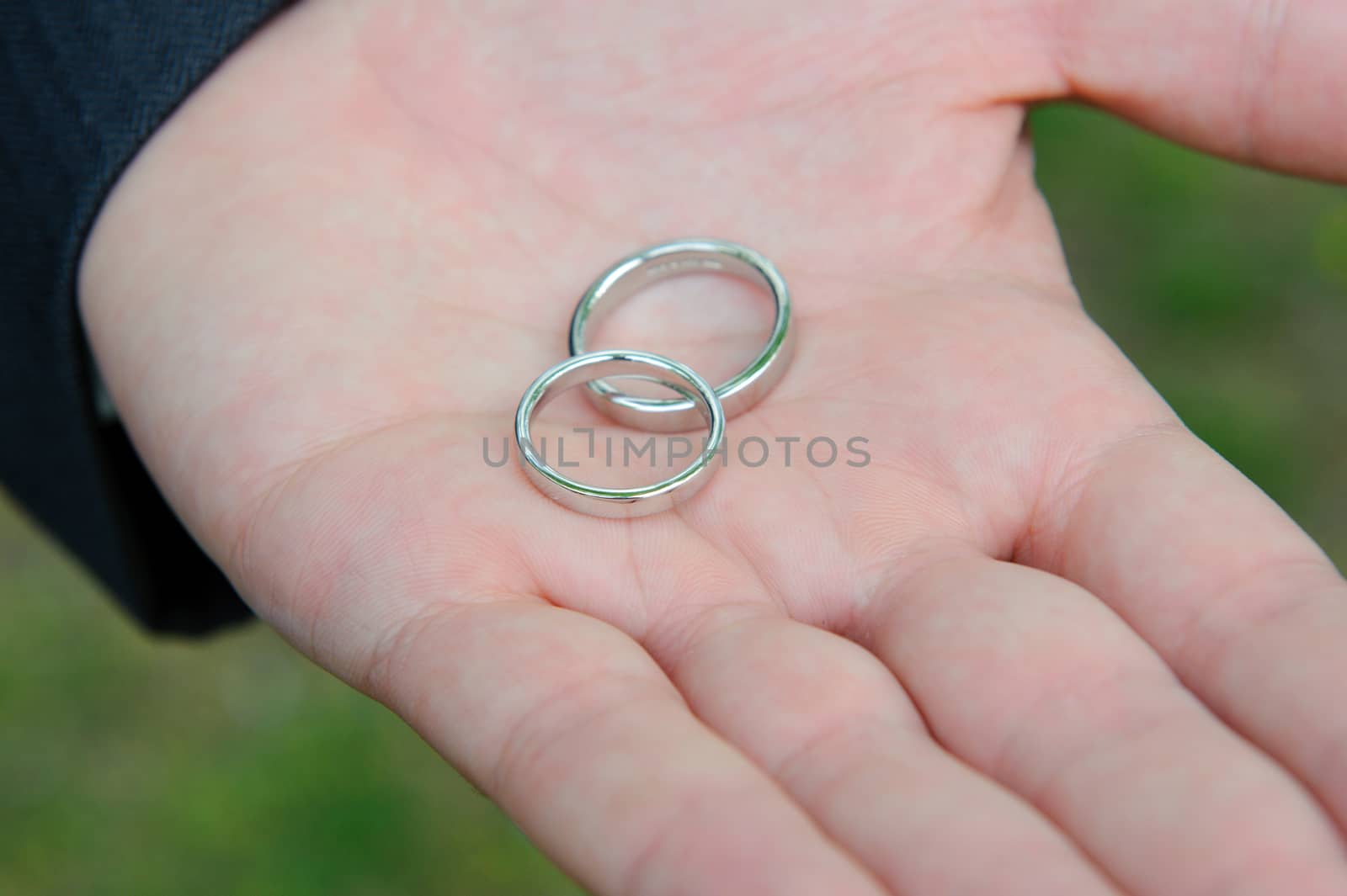 White gold wedding rings in grooms hand