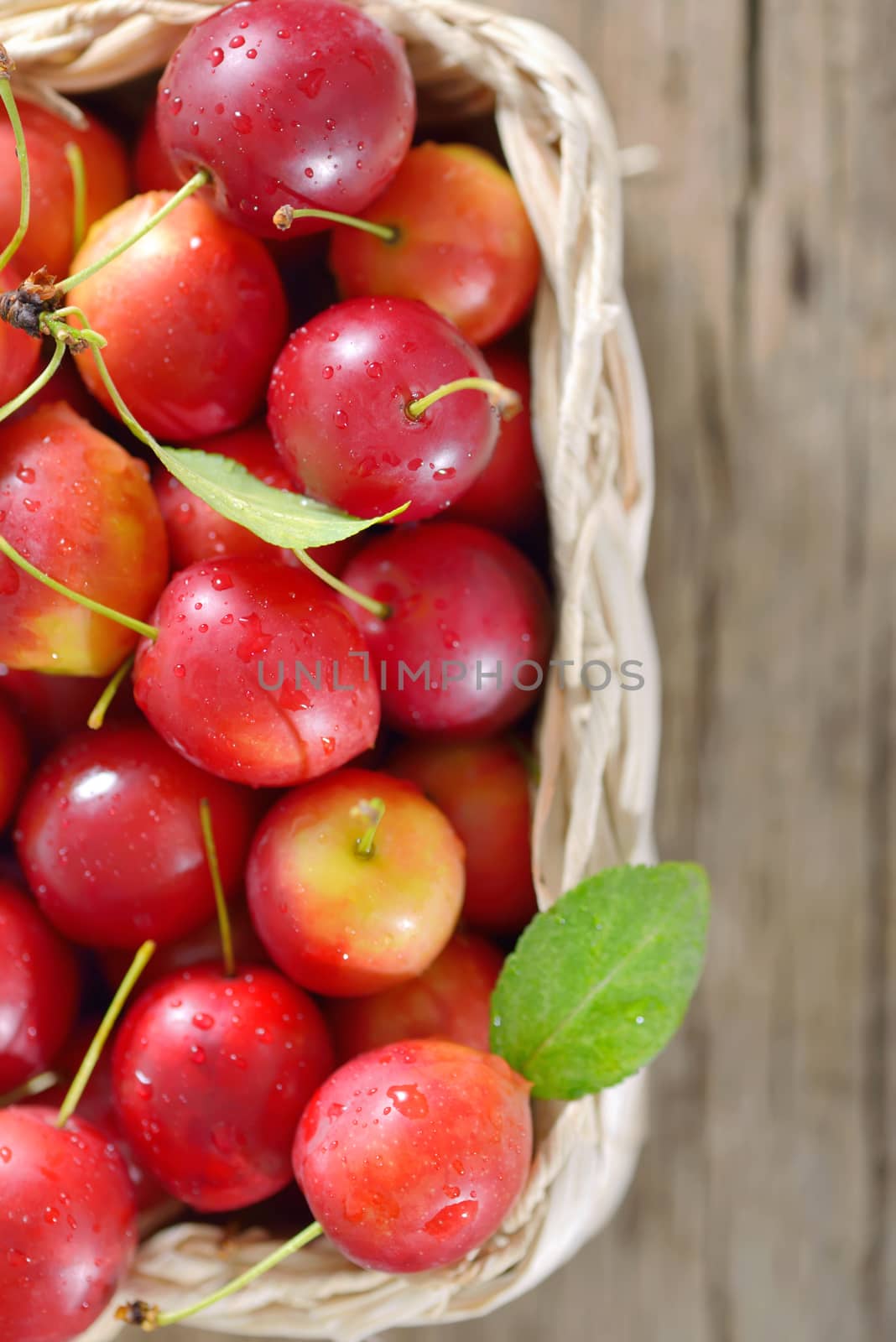 cherry-plum in basket on wooden background

