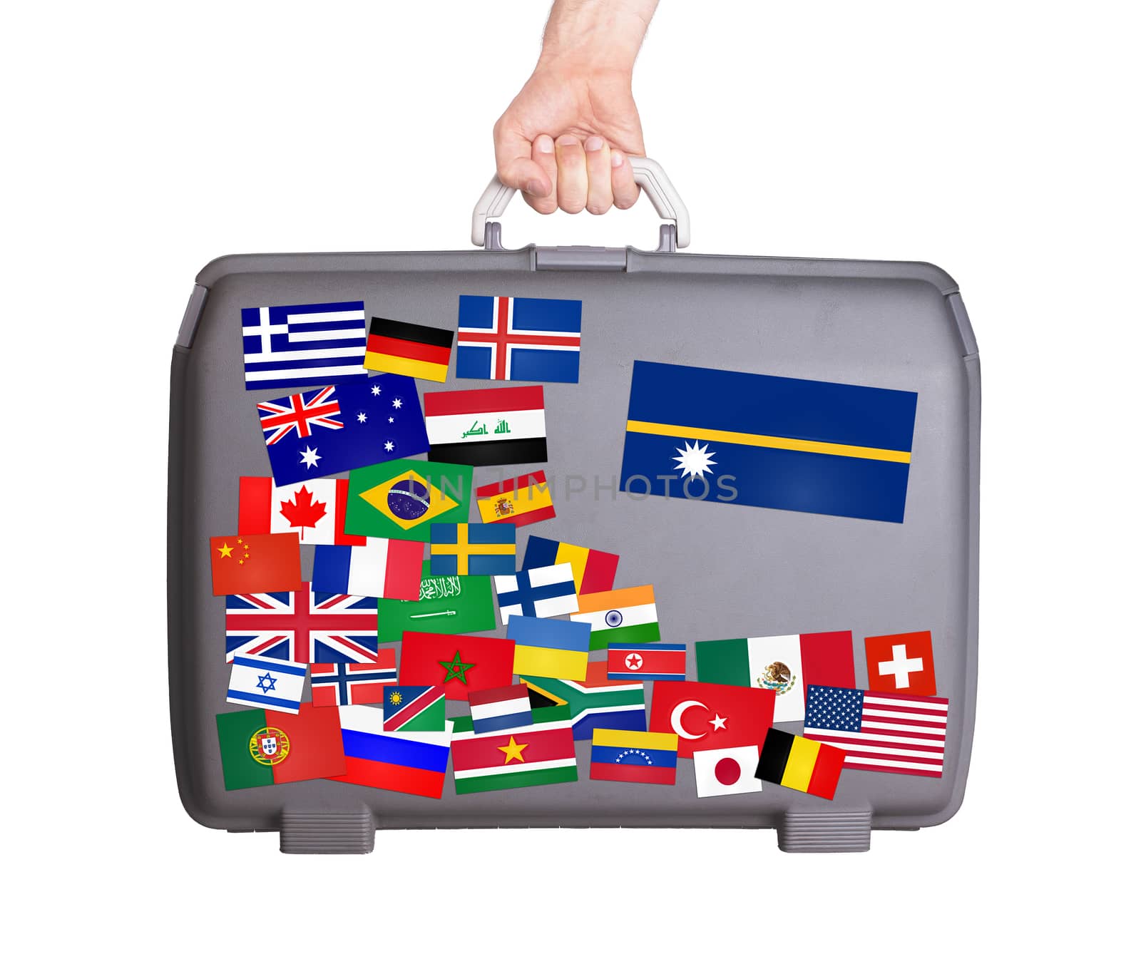 Used plastic suitcase with lots of small stickers, large sticker of Nauru
