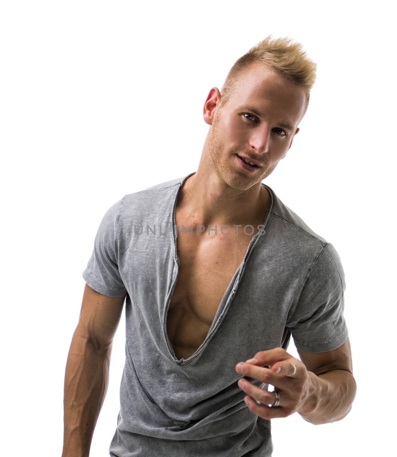Fit male model with a lot of confidence smiling and pointing on white background