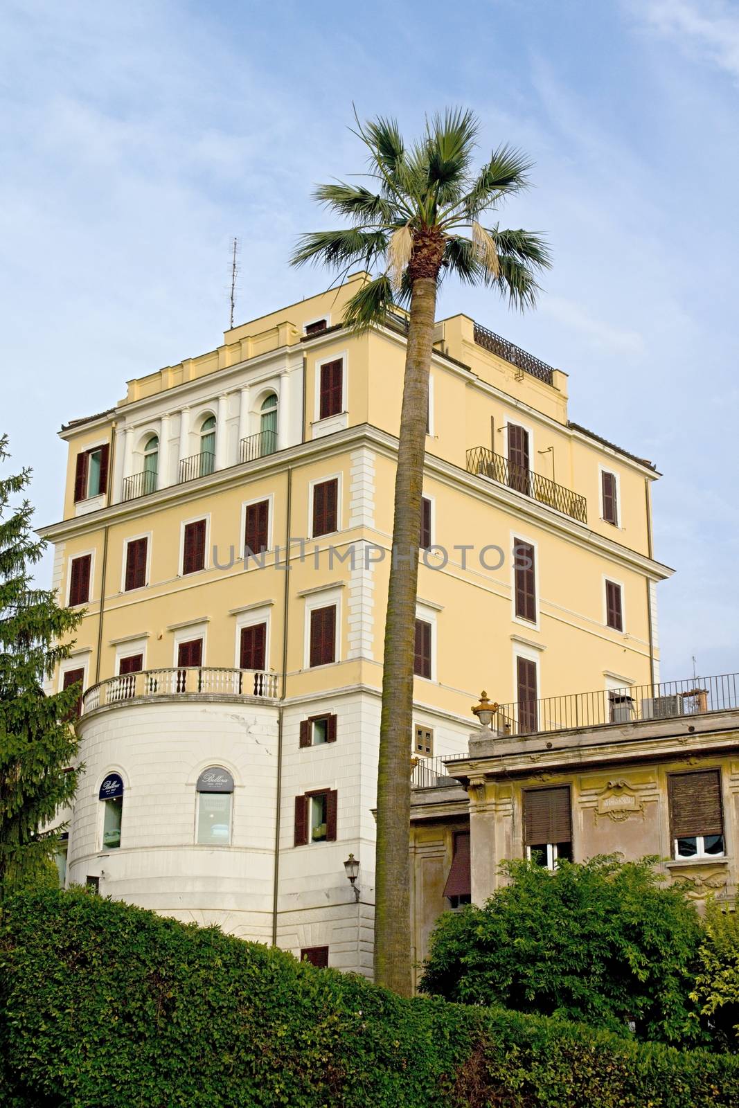 Photo shows Rome cityscape with houses and roofs.