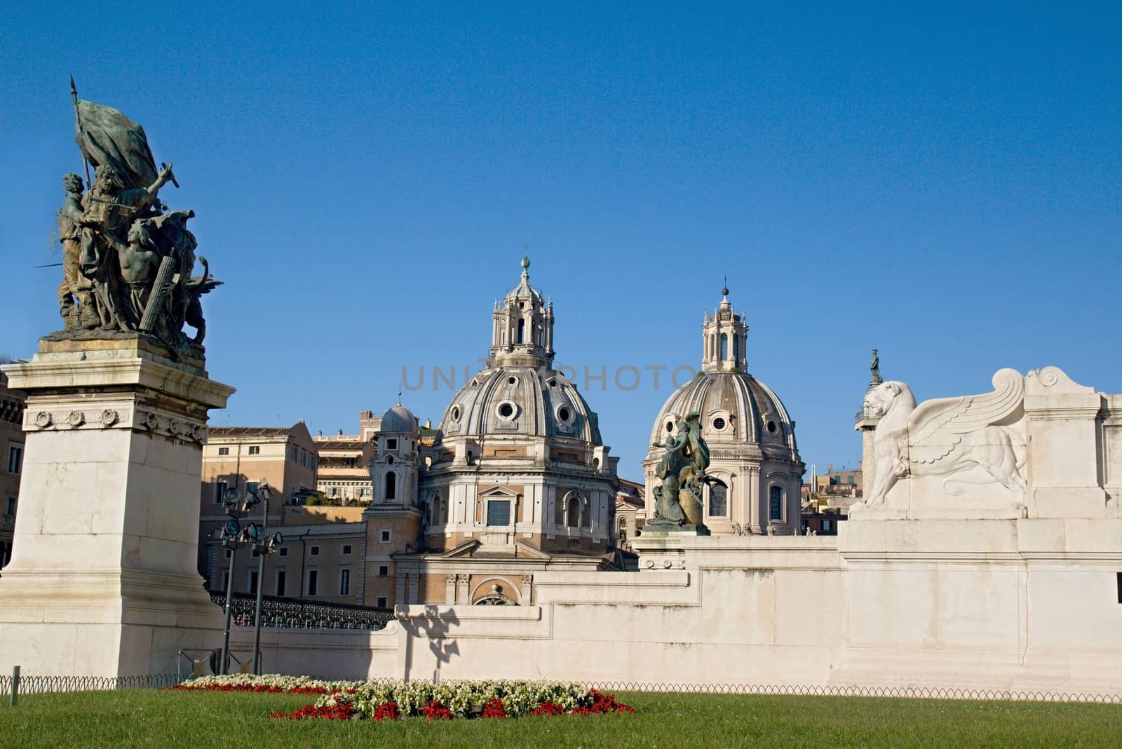 Photo shows Rome cityscape with houses and roofs.