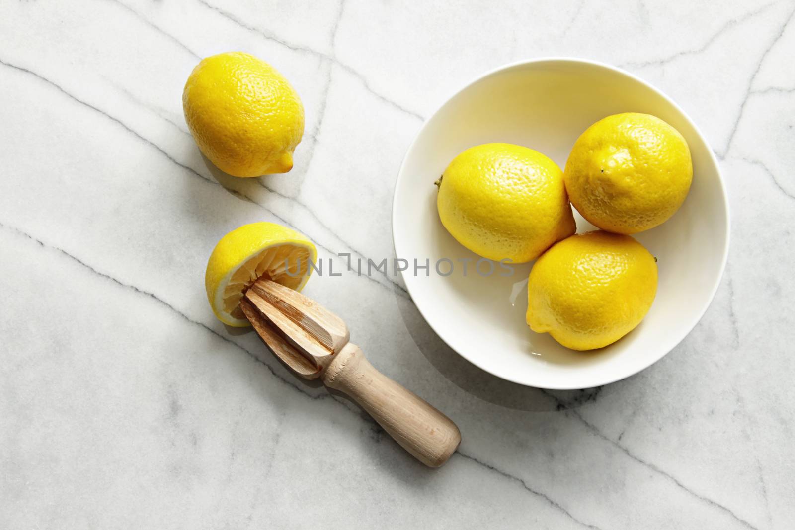 Fresh lemons on marble counter by Sandralise