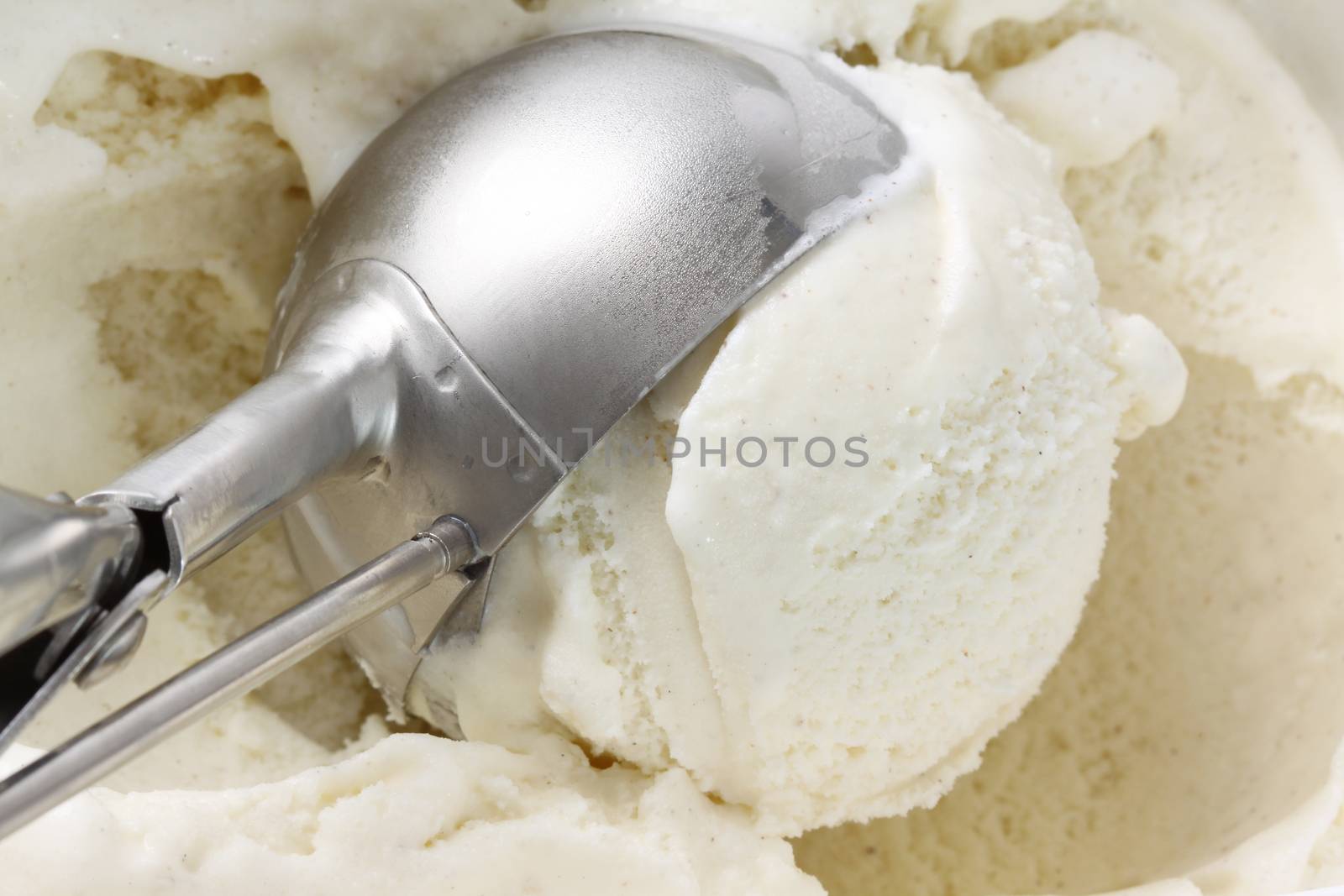 Scoop of vanilla bean ice cream from container