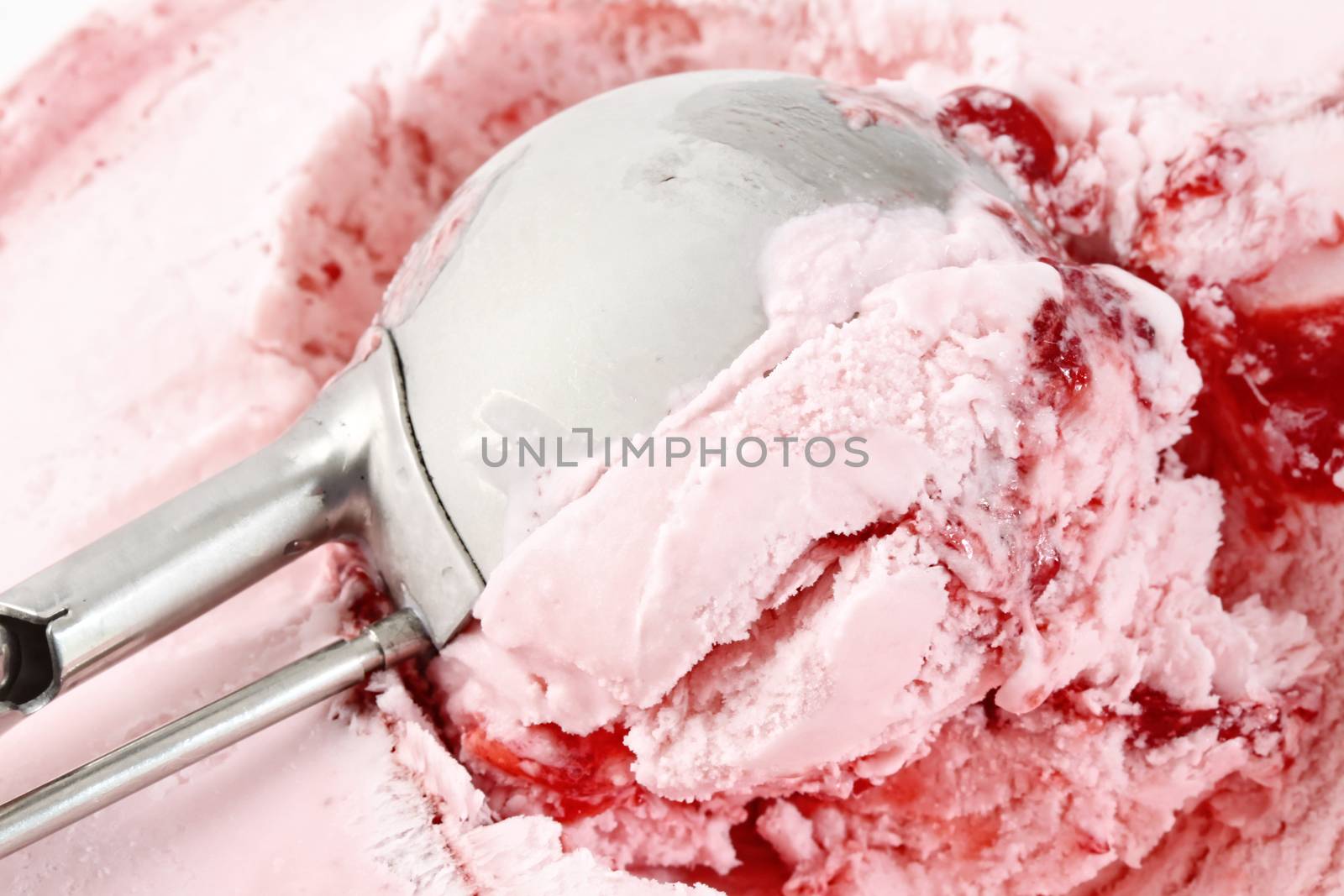 Scoop of strawberry ice cream from container 