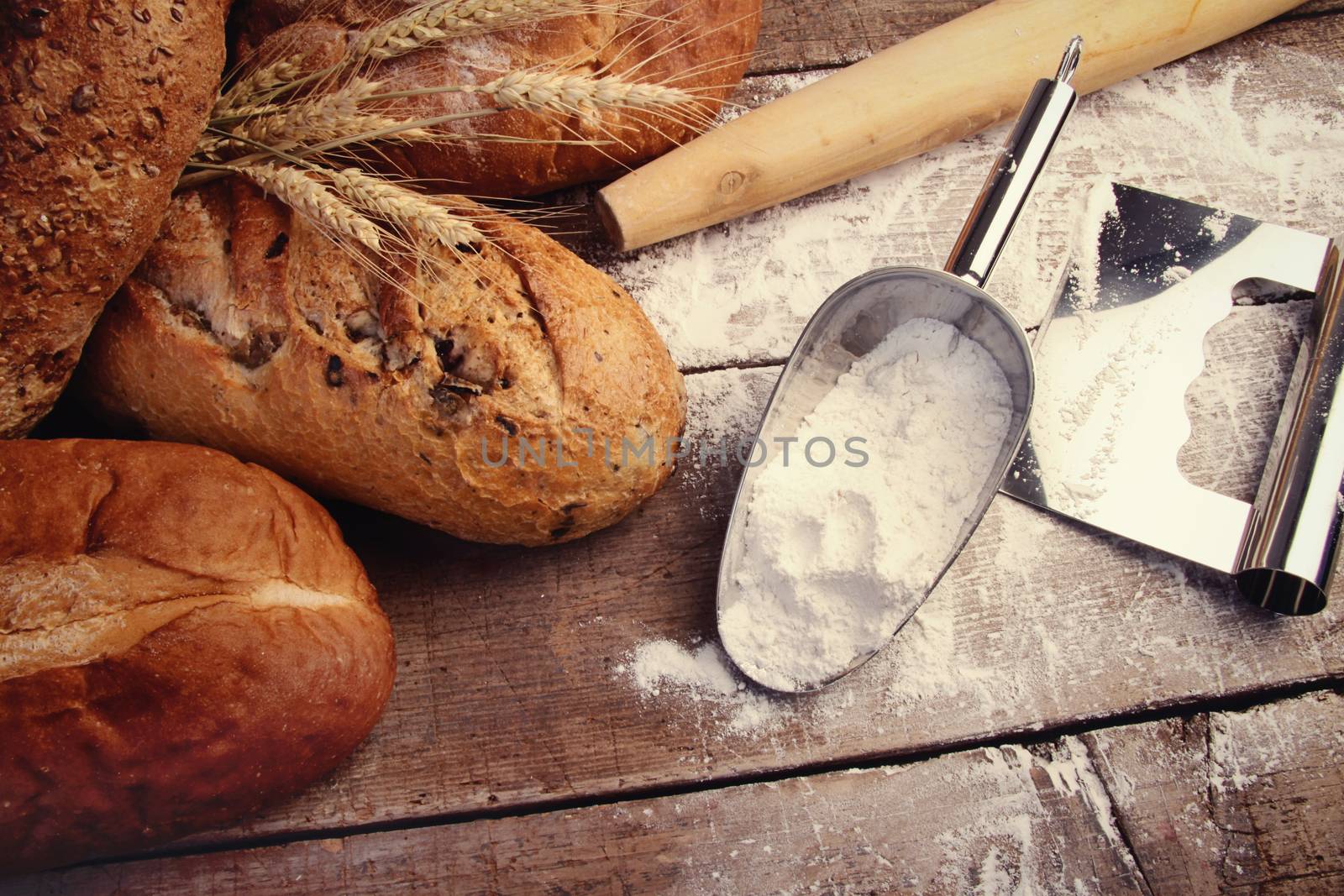 Homemade breads with cooking utensils by Sandralise