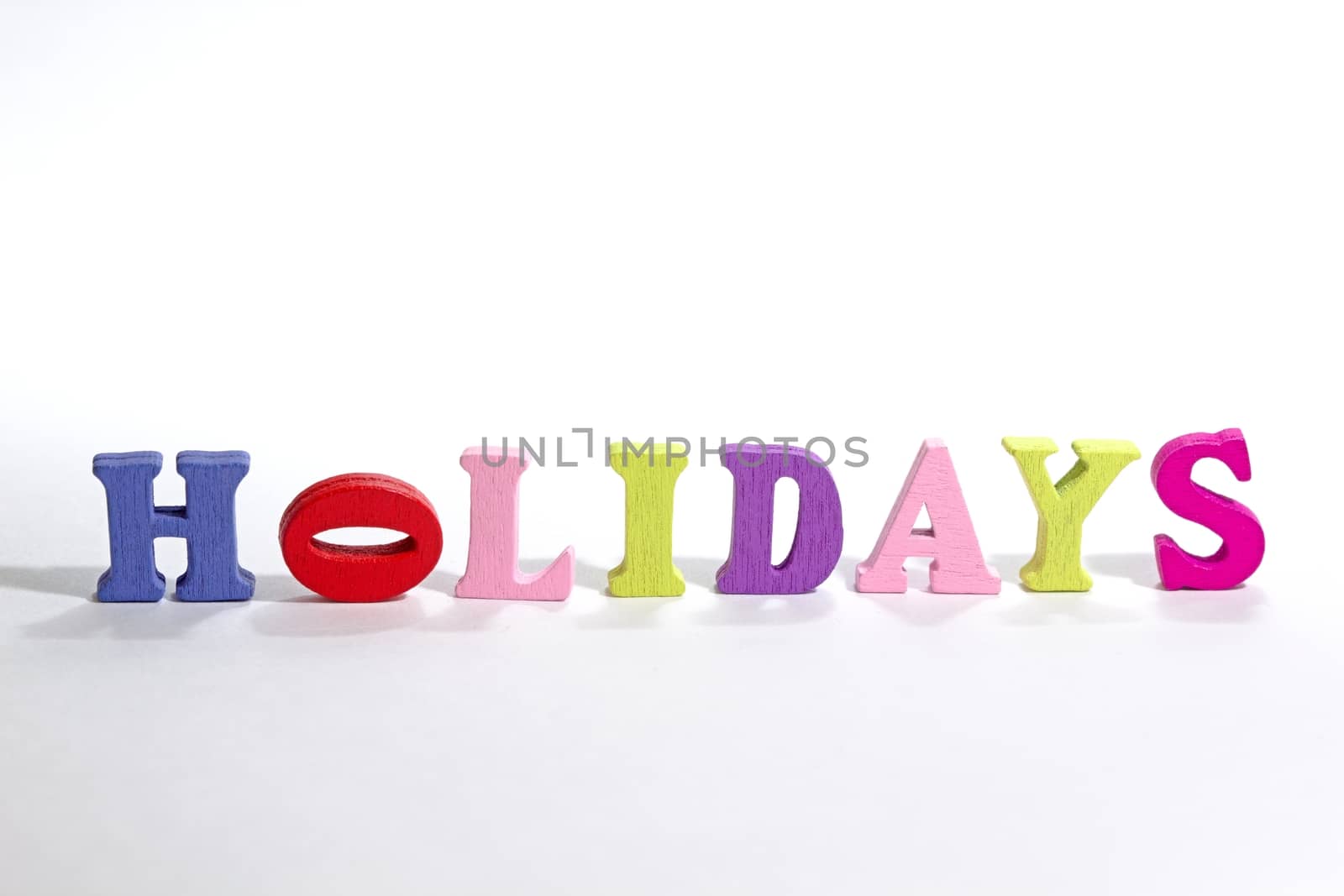 Photo shows detail of holidays sign on white background.