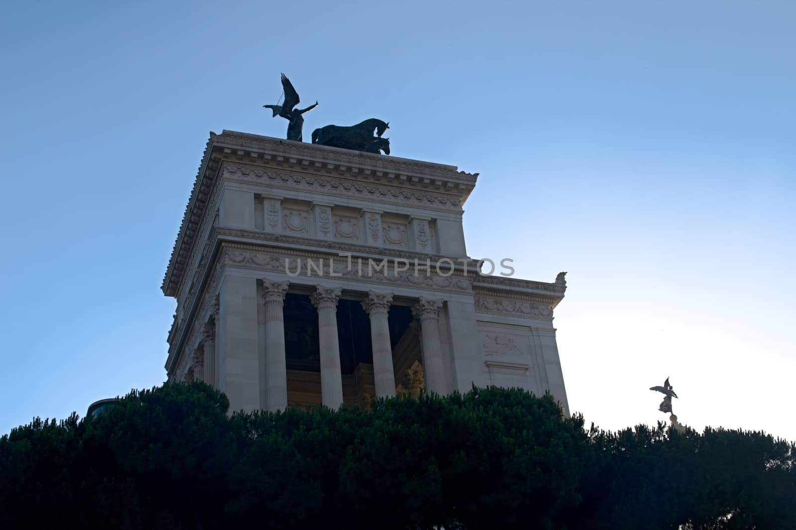 Photo shows Rome cityscape with houses and roofs.