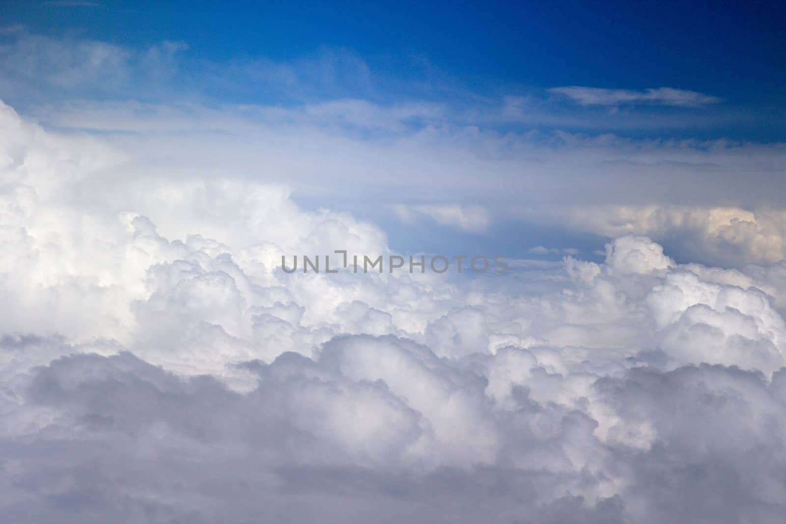 Photo shows details of white clouds and blue sky.