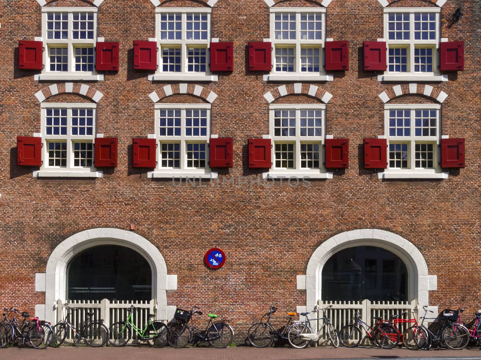 Brick facade with windows and bicycles in Amsterdam