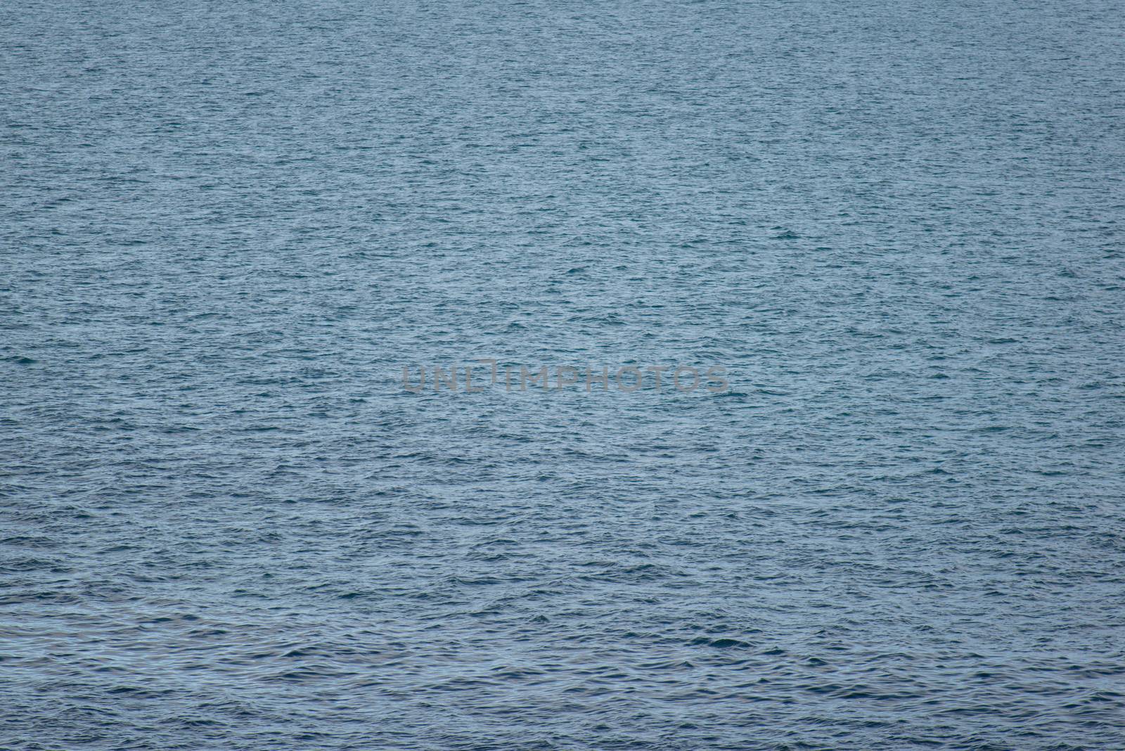 Background of ocean water around Greenland with water surface in light wind