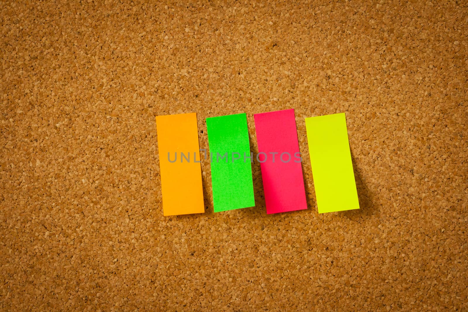 image of color blank post-it reminder on corkboard