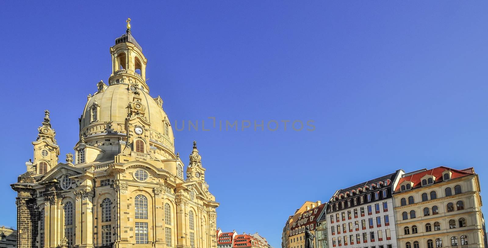 Church Frauenkirche with resident buildings in Dresden Germany on a sunny day with blue