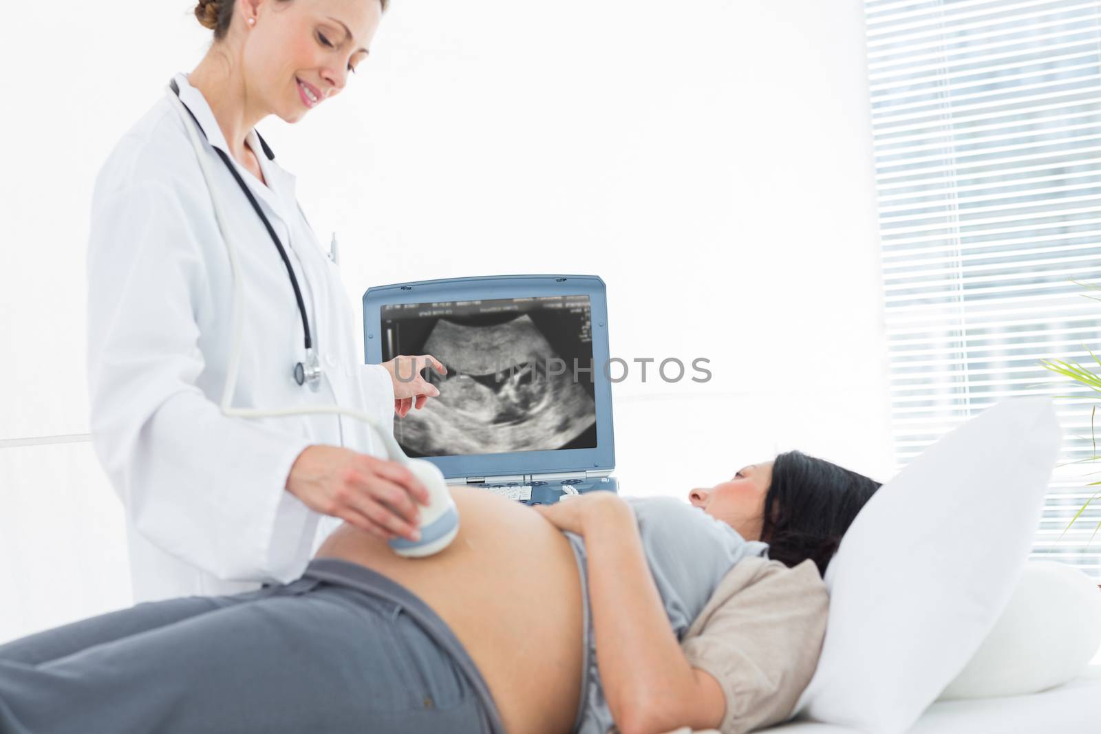 Doctor doing ultrasound pregnant woman by Wavebreakmedia
