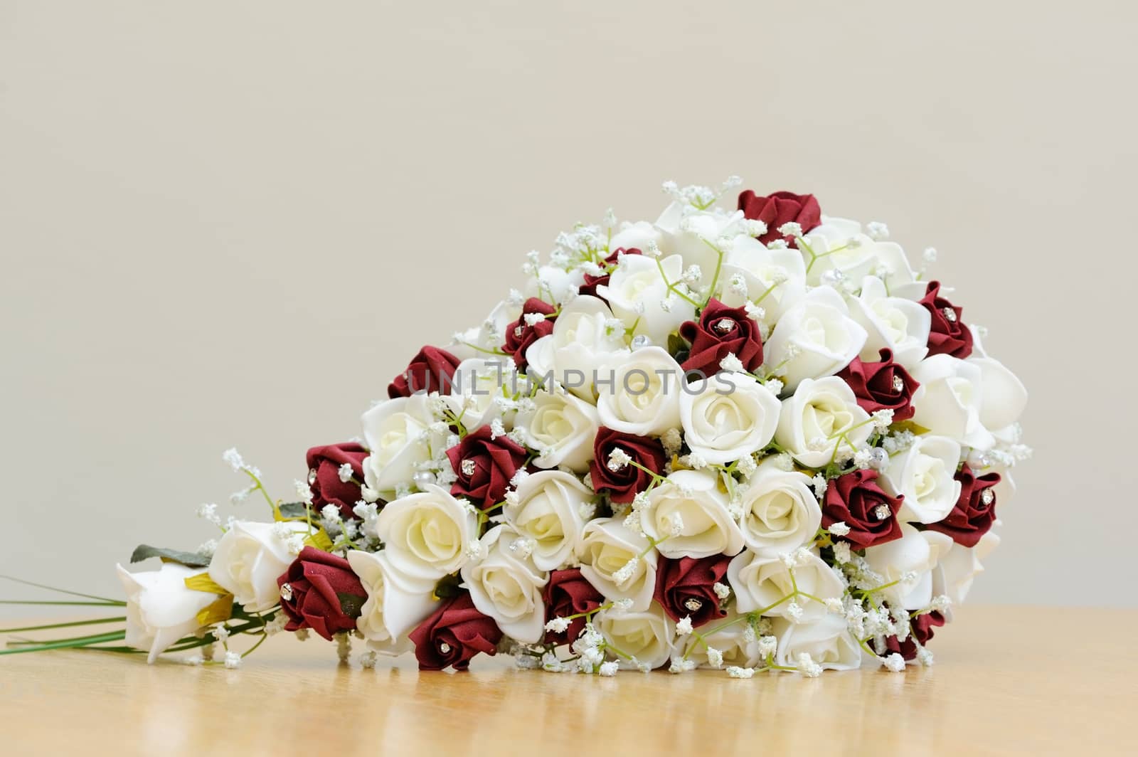 Bouquet of artificial red and white roses for bride