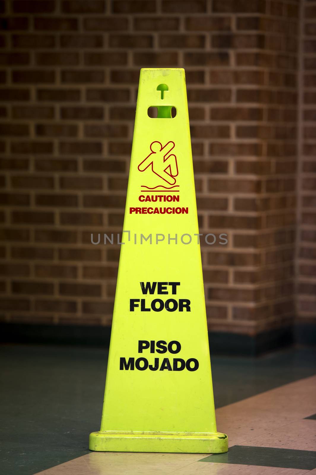 Caution Wet floor sign agaist a bathroom 