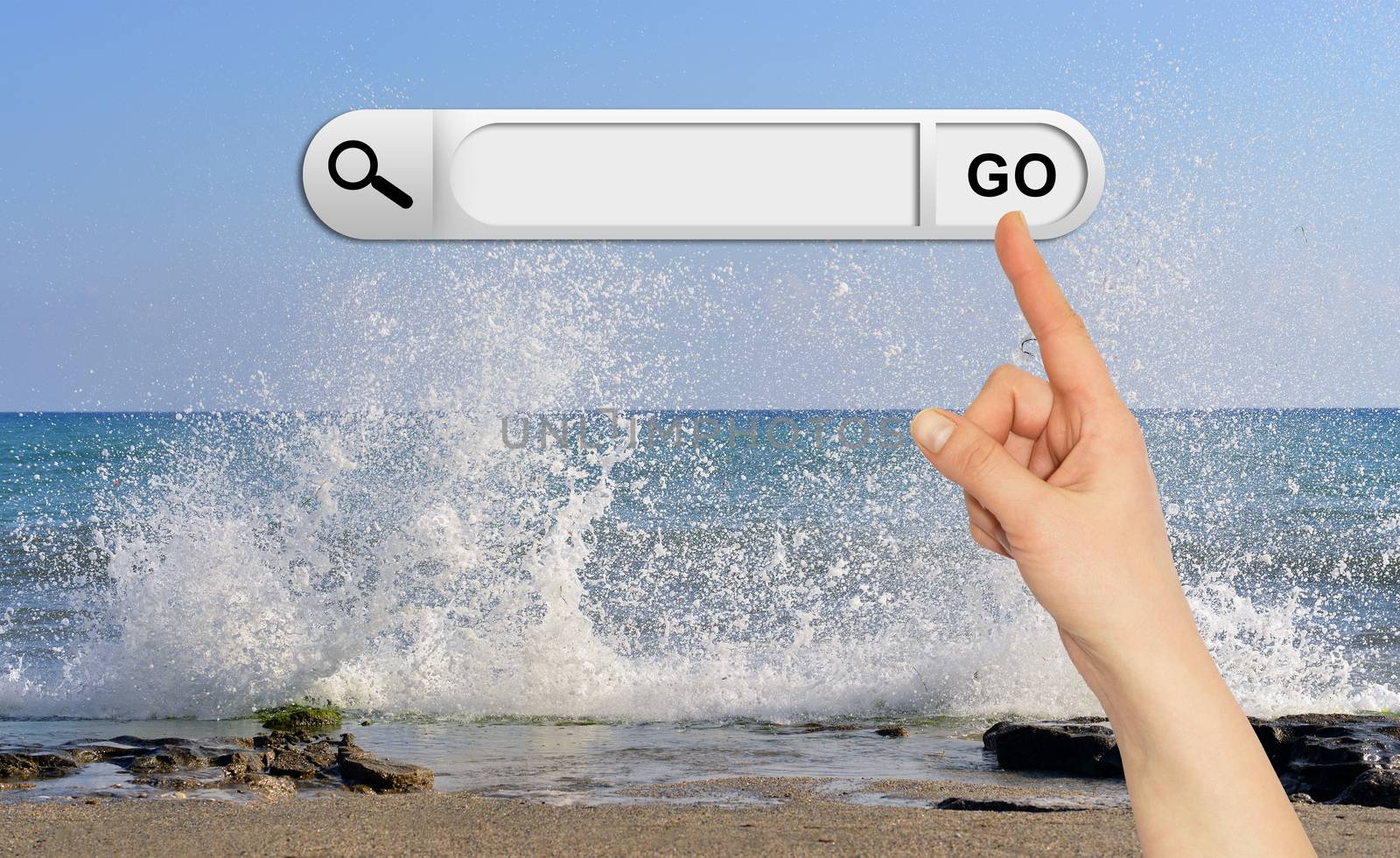Human hand indicates the search bar in browser. Waves breaking on stony beach as backdrop