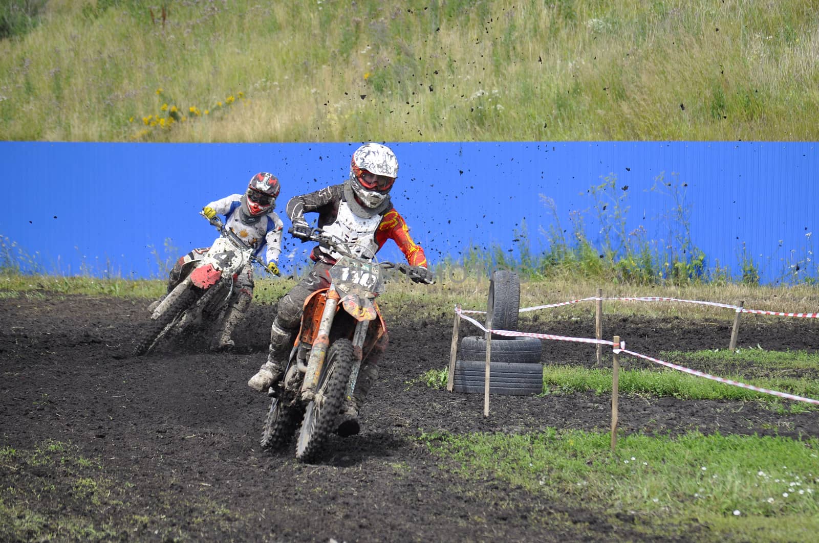 Racers on motorcycles participate in cross-country race competit by veronka72