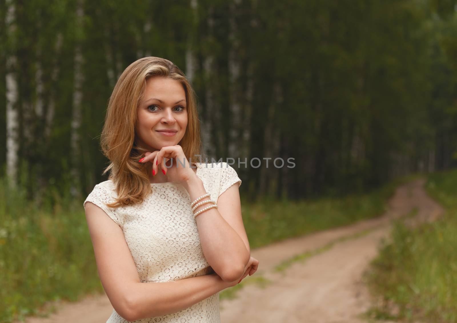 Sexy girl blonde on a green background of the nature