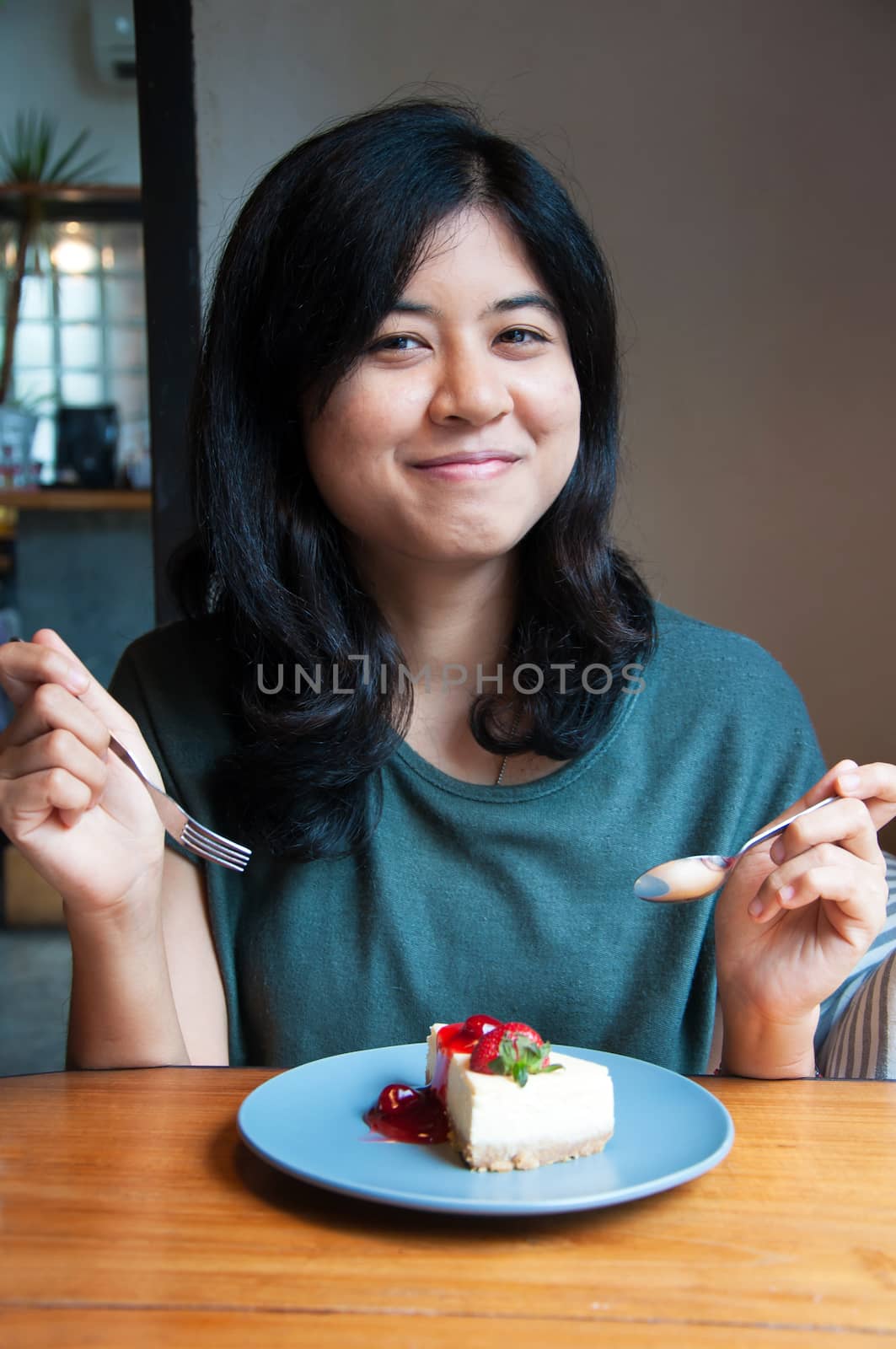 Beautiful smiling young woman with a cake 