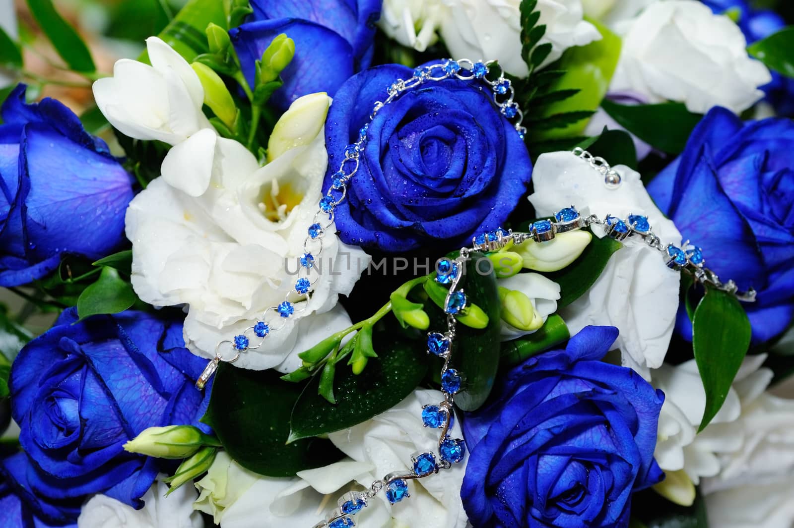 Brides blue rose bouquet and blue gem bracelets