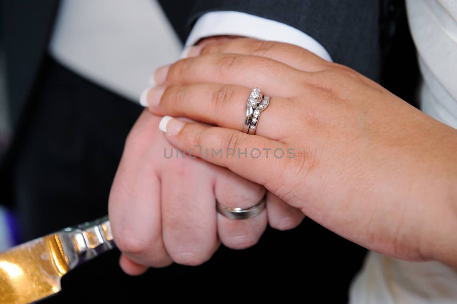 Bride and groom at wedding closeup of hands showing rings