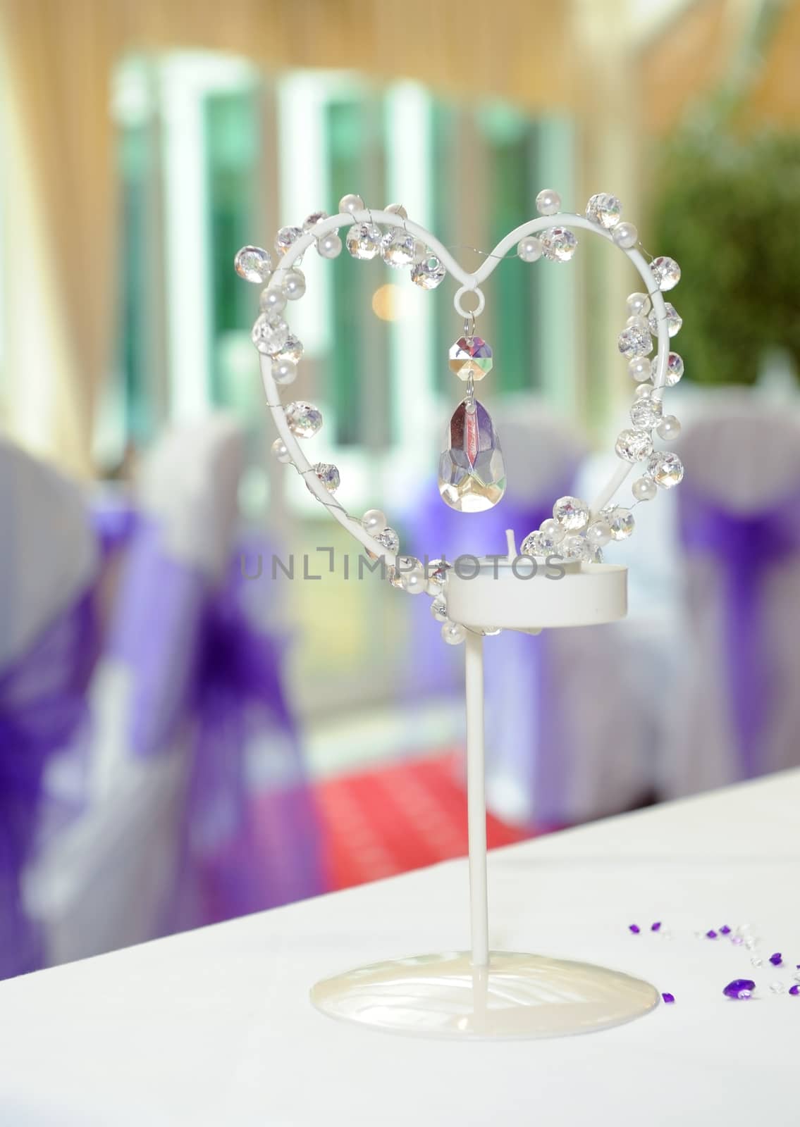 Heart shaped candle holder at wedding reception