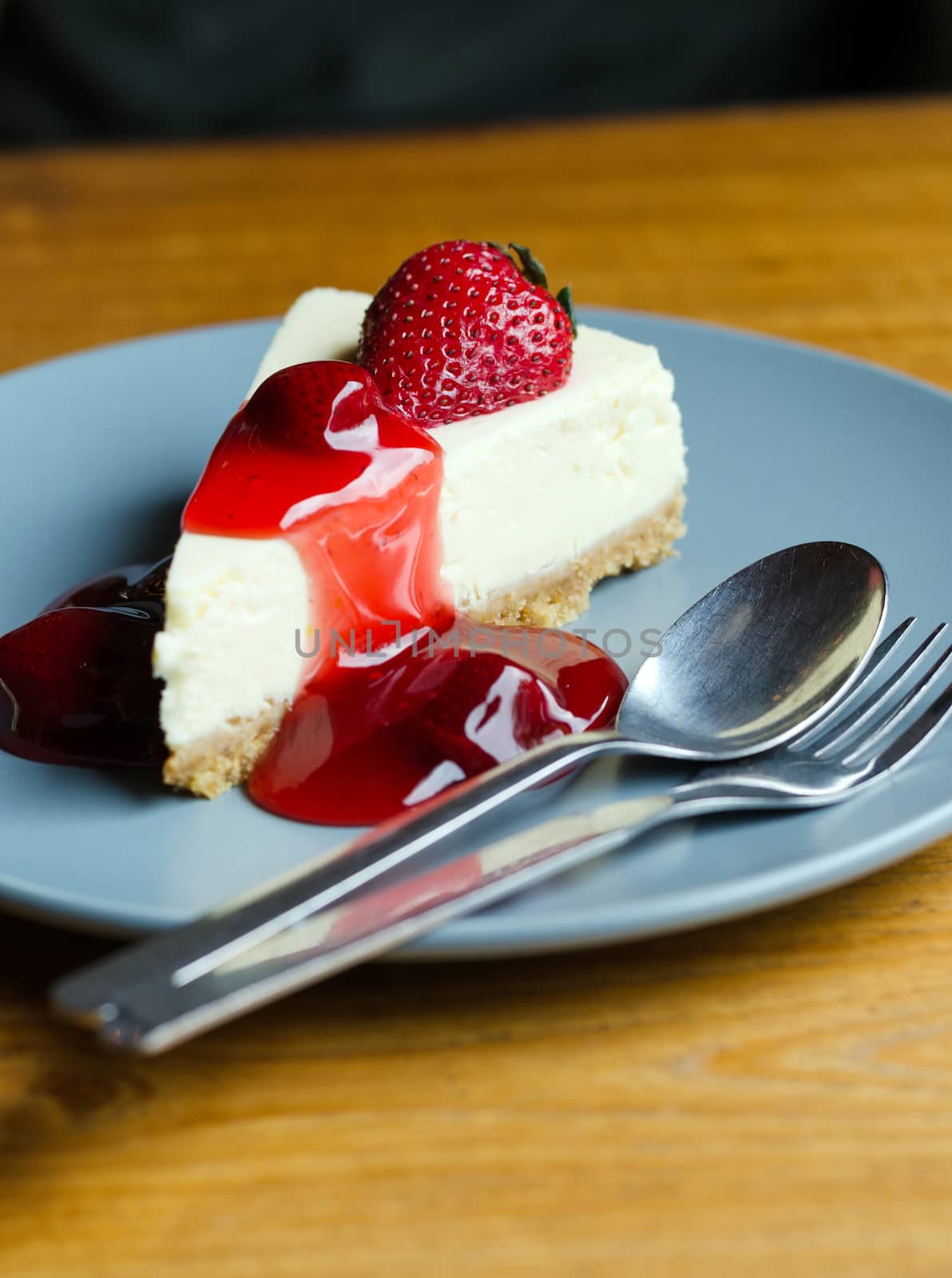 Fresh Strawberry Cheesecake with spoon and fork on dish