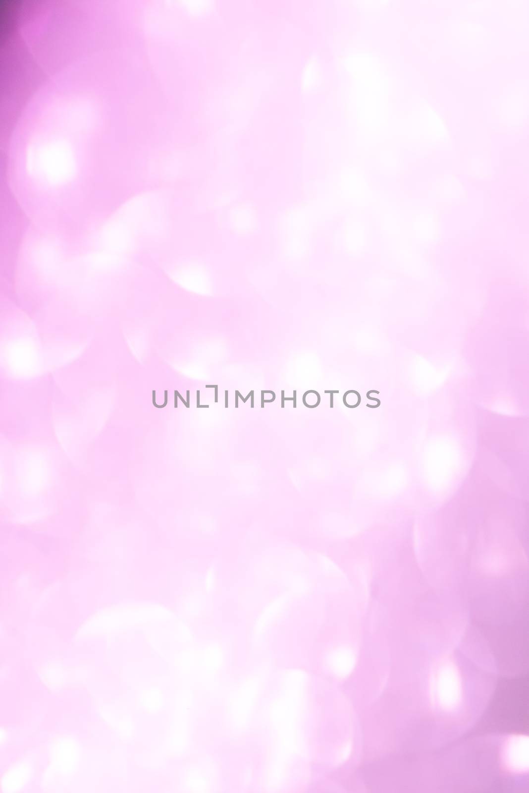 Abstract background of pink holiday lights with copy space.