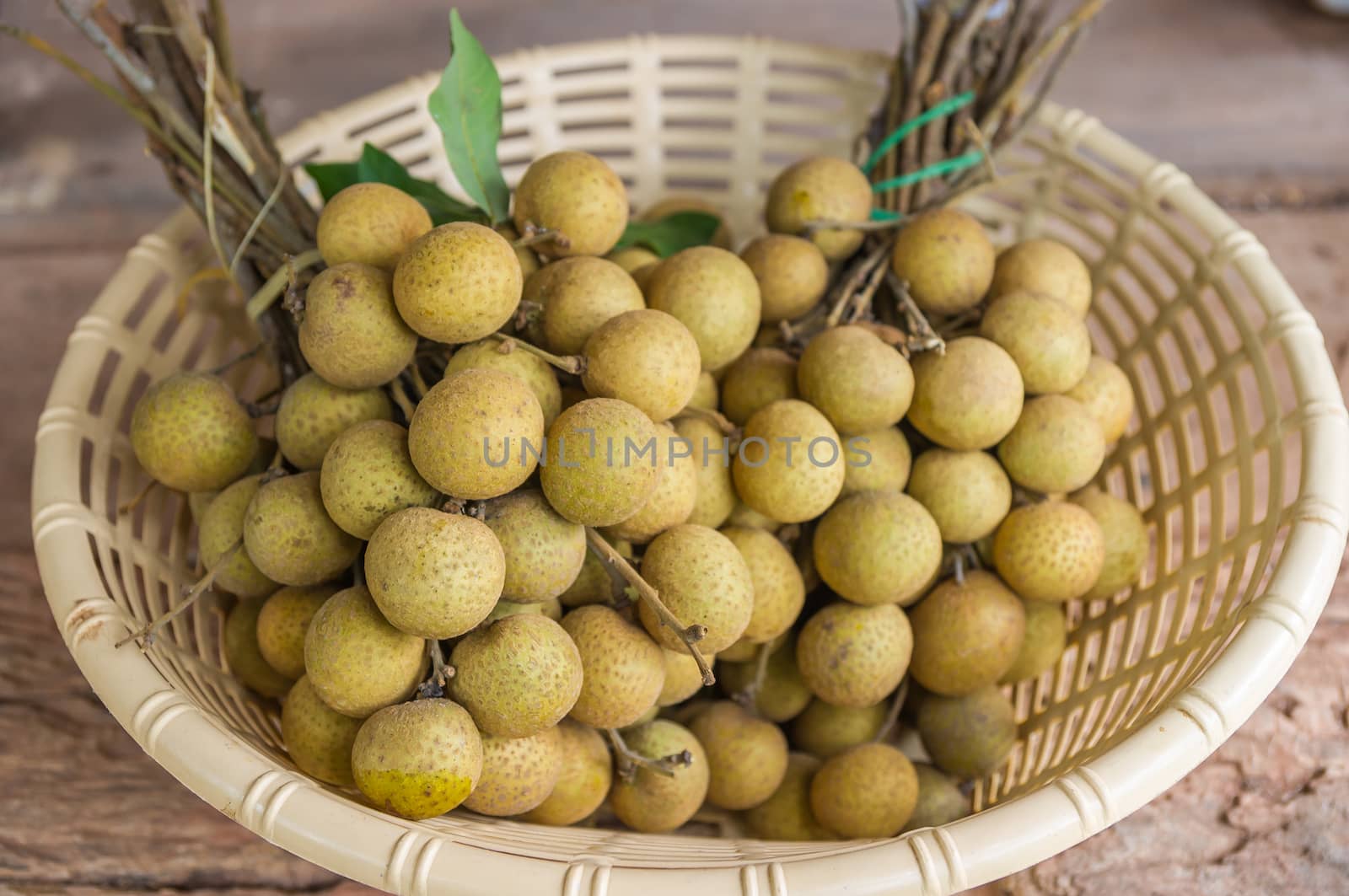 Fresh longan fruits in basket.