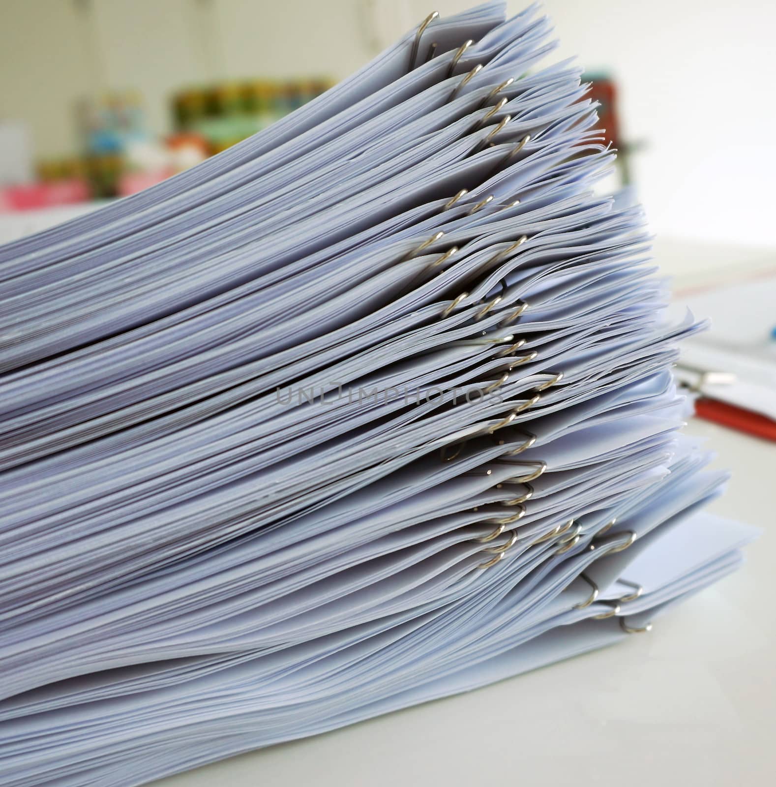 Handouts were arranged in a series, stacked on table outside meeting room.                              