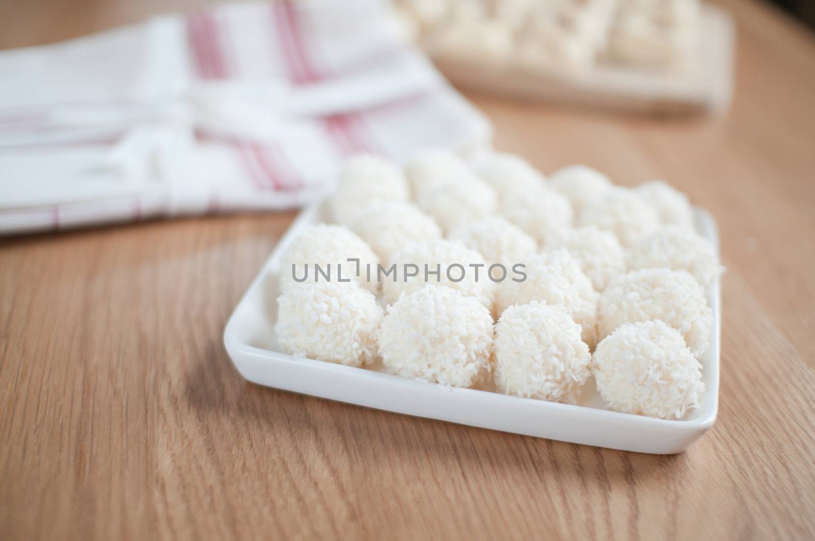 Coco balls in plate on the table by anytka
