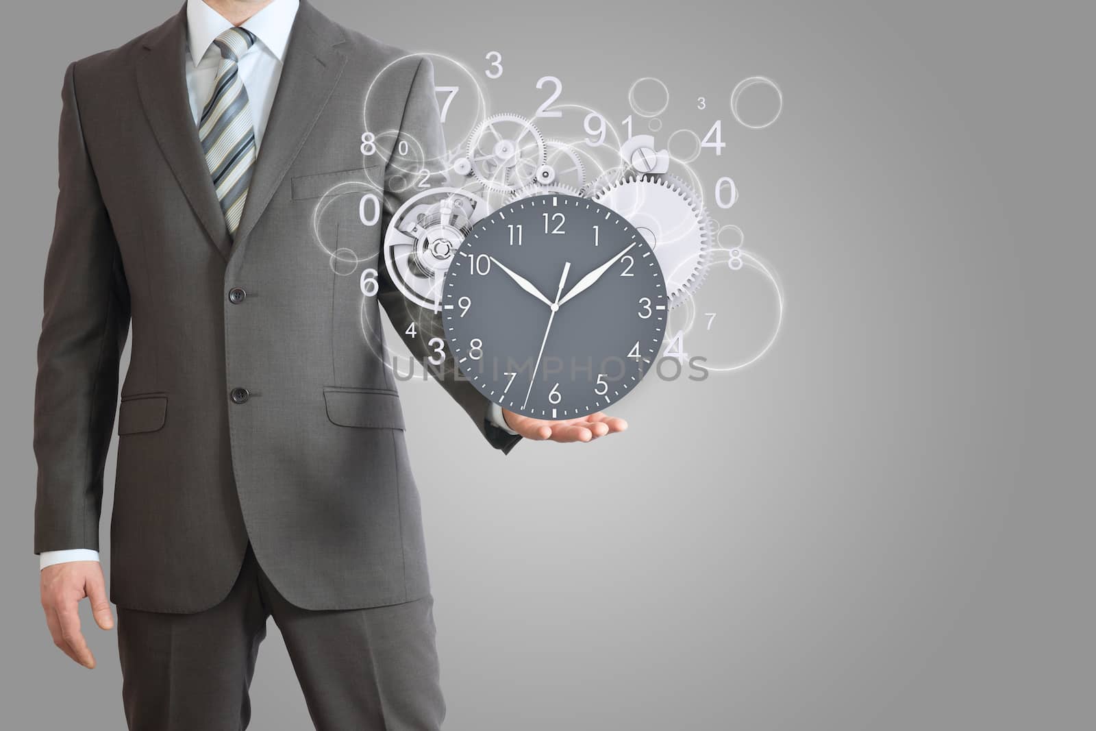 Businessman hold clock with gears. Gray background