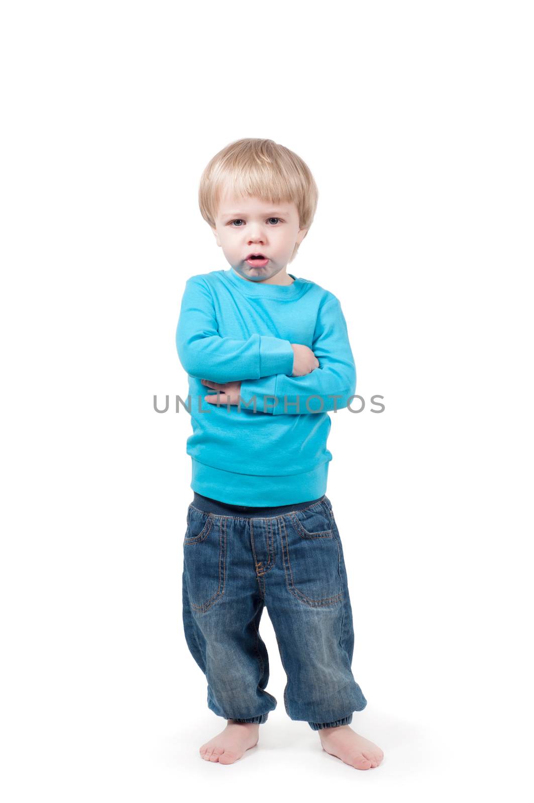 Portrait of a serious boy with crossed arms looking at camera