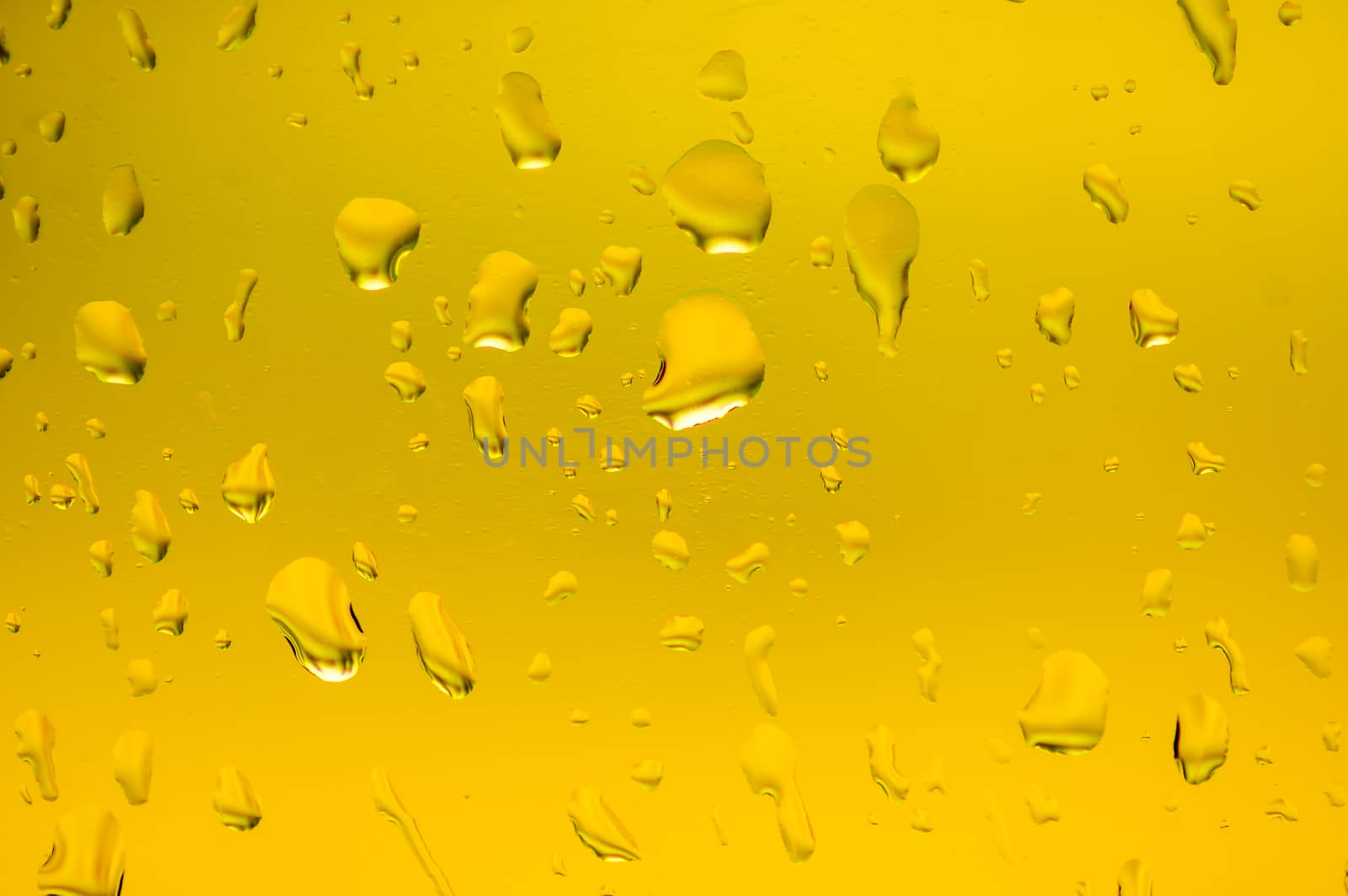 Drops of water on glass gold color.