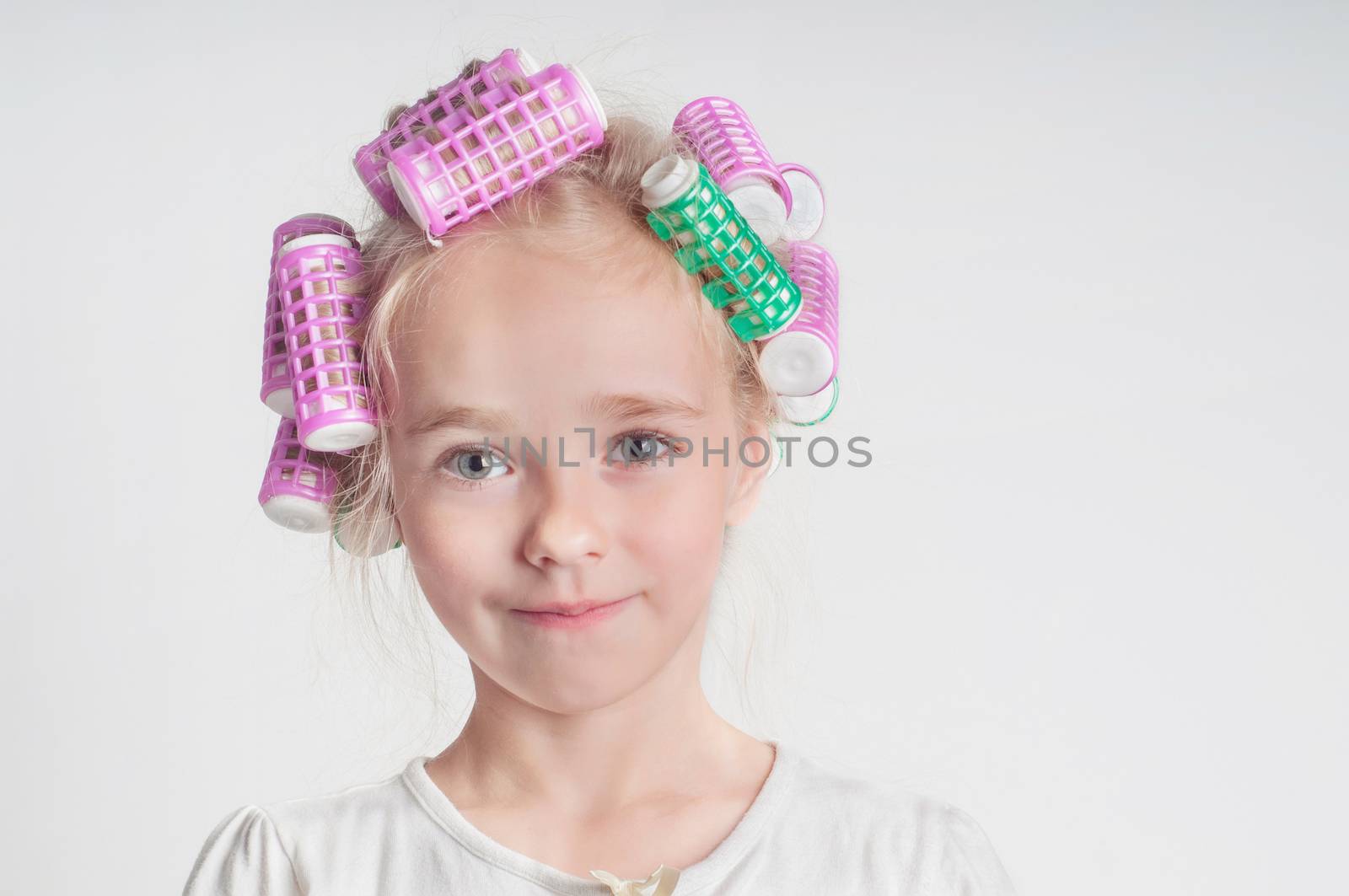 Adorable child girl portrait in curlers by anytka