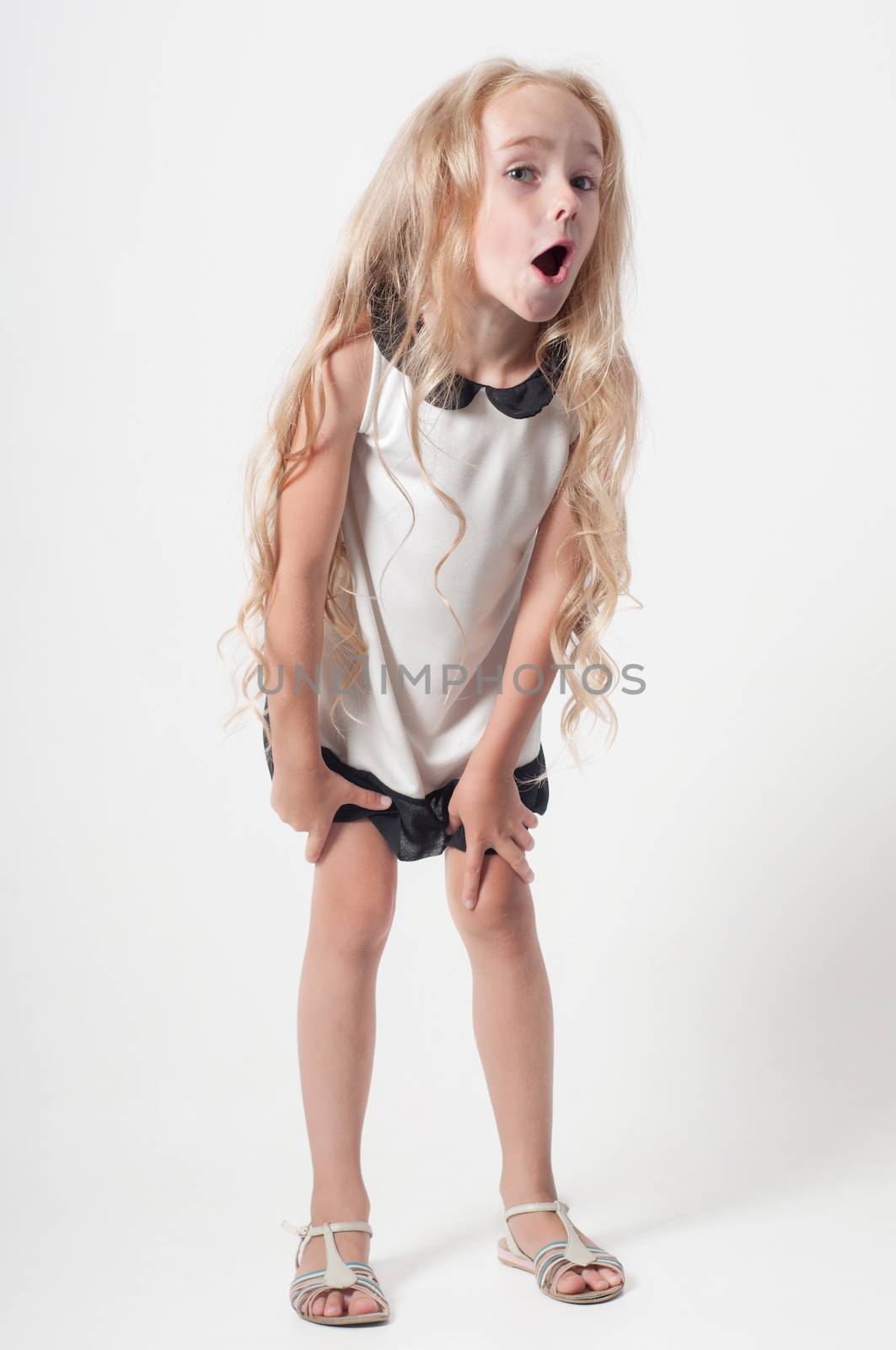 Little girl in white dress fooling around by anytka