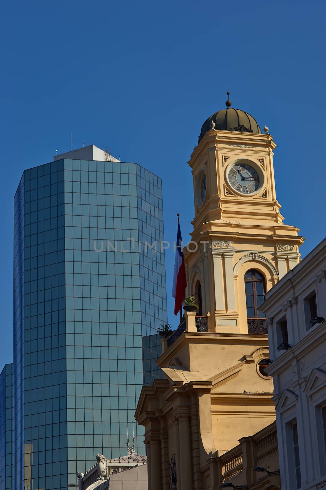 Historic building housing the Chilean National History Museum along site a modern office block in the Plaza de Armas in Santiago, Chile