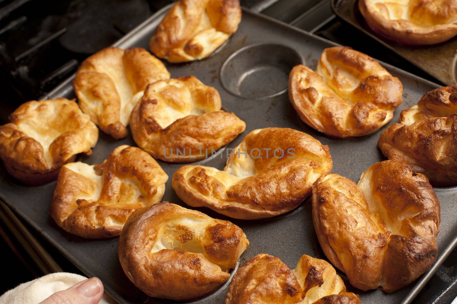 Traditional English Yorkshire puddings made from batter in a baking tray waiting to accompany a meal of roast beef