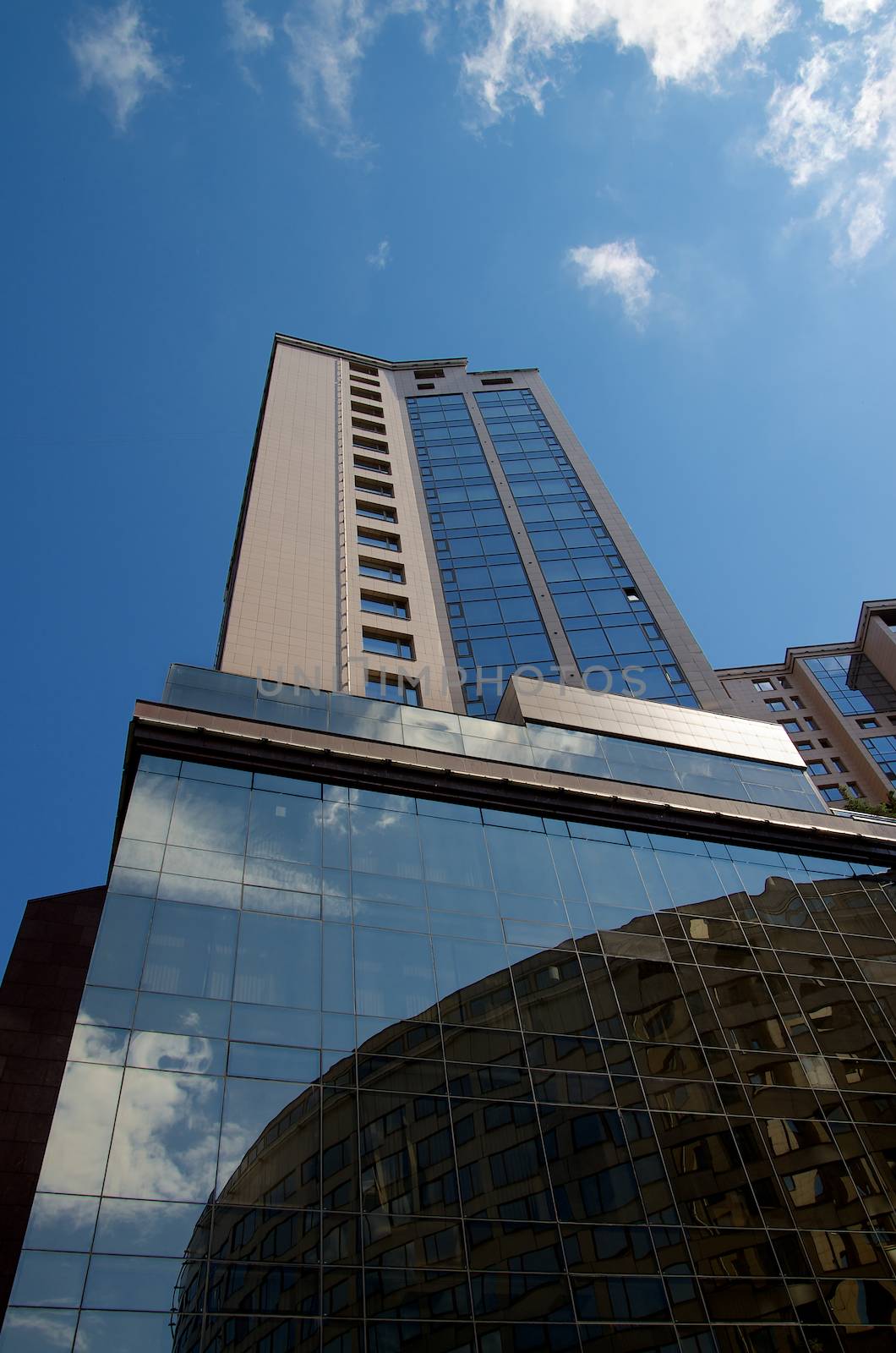 Contemporary Mirrored Modern Buildings on Blue Sky background Outdoors. Bottom Up View