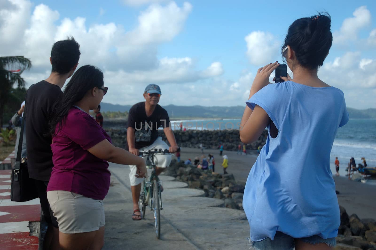 Pangandaran, Indonesia - July 16, 2011: Man riding a bike at Pangandaran beach shore, West Java-Indonesia.