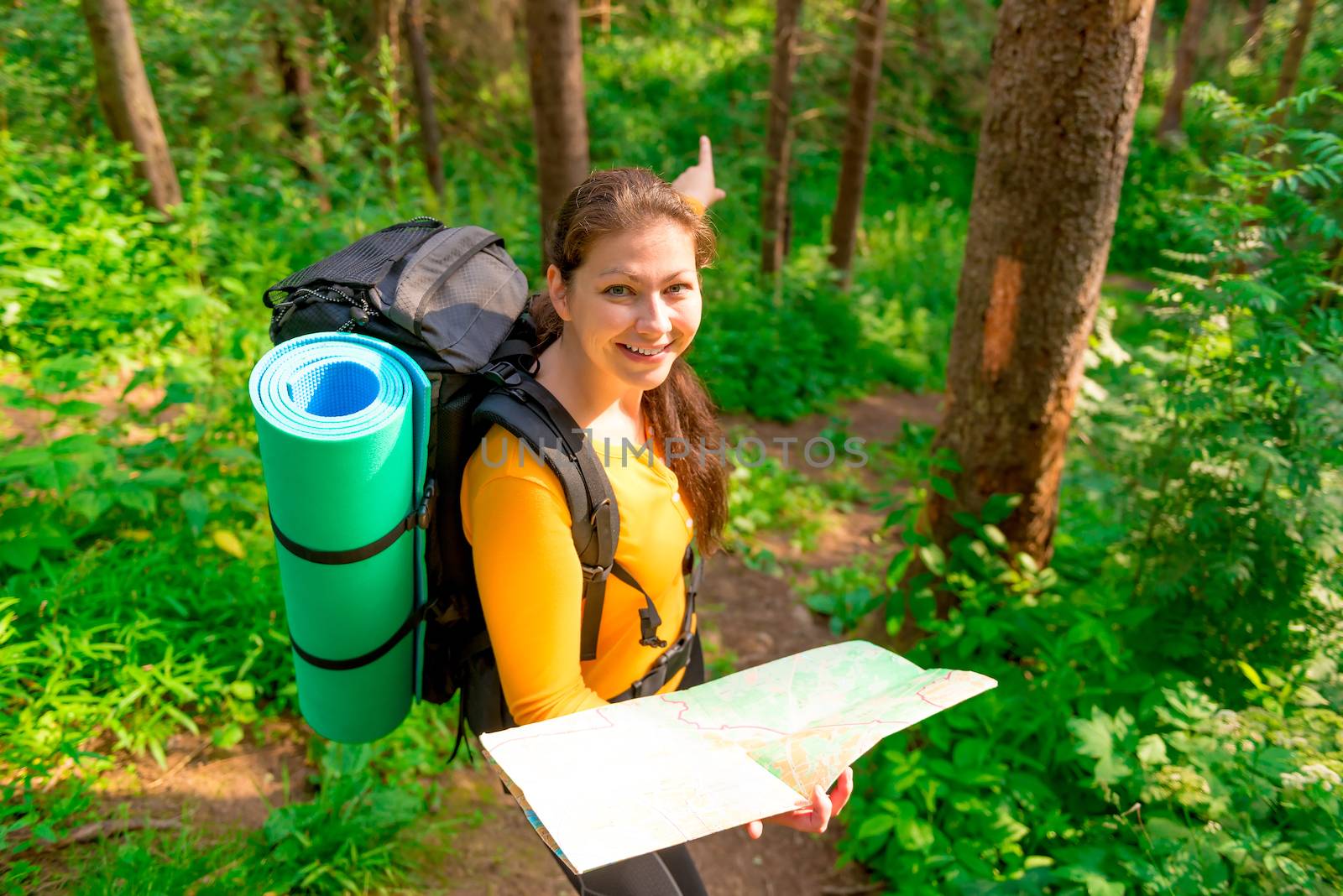 cheerful tourist shows the desire direction of travel