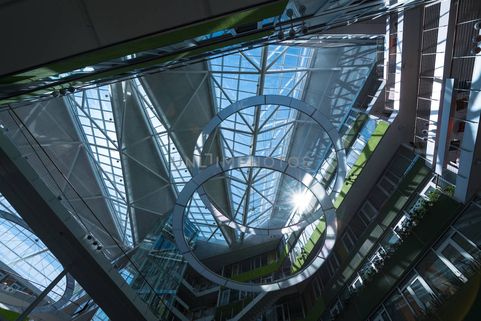 view up the glass roof of a modern office building hall