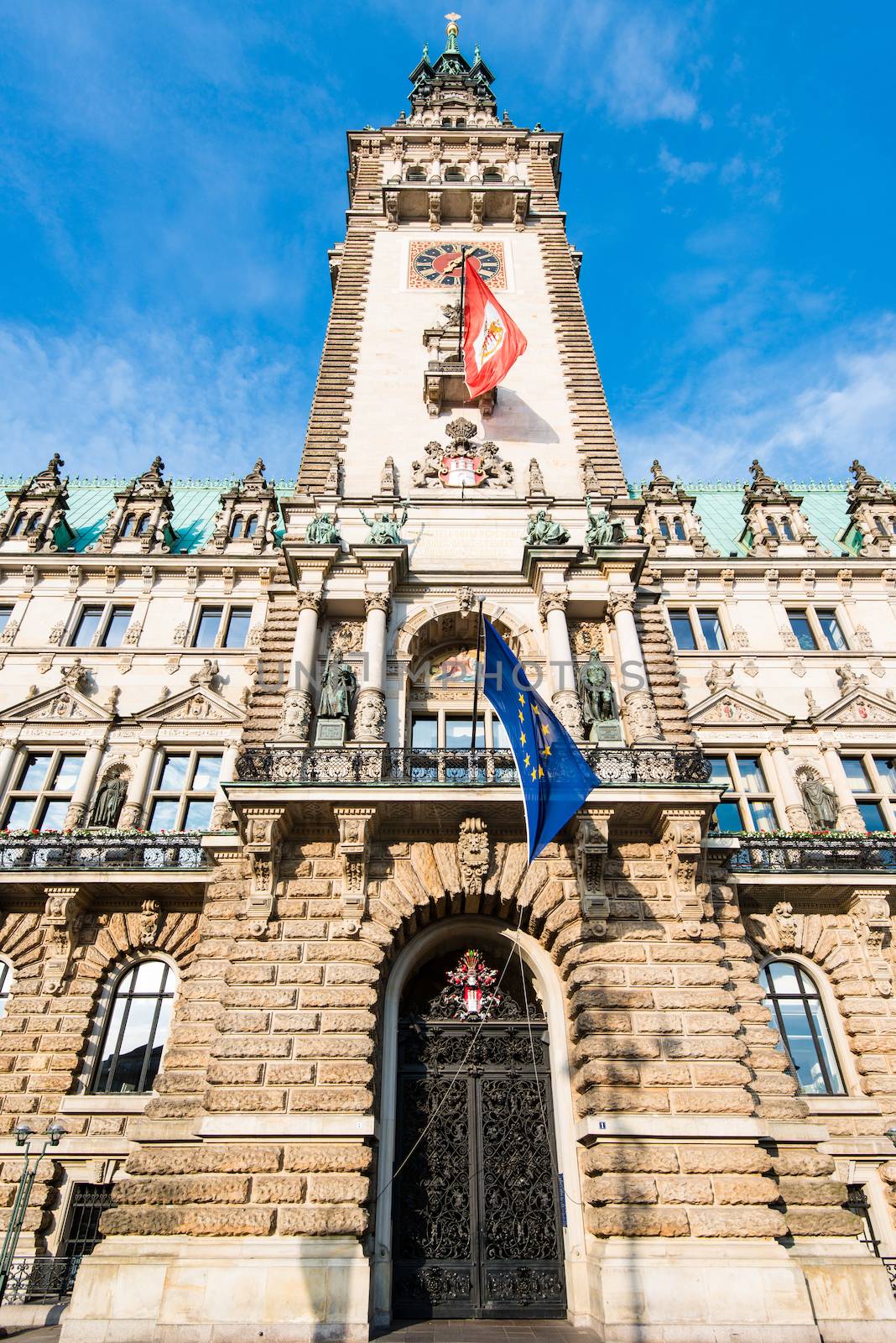 The historical townhall of Hamburg, Germany with local and European flags